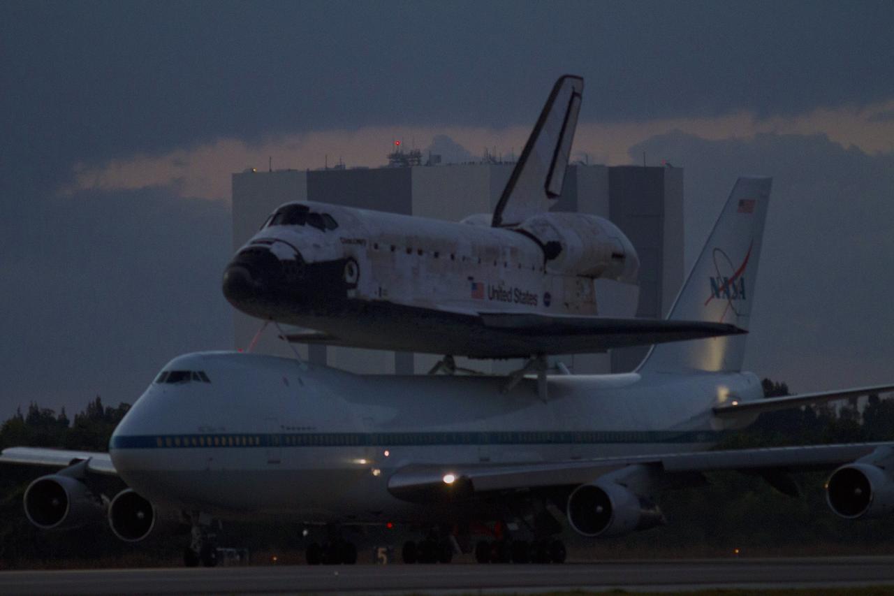 CAPE CANAVERAL, Fla. – In the early morning hours at NASA Kennedy Space Center’s Shuttle Landing Facility in Florida, the Shuttle Carrier Aircraft, or SCA, with space shuttle Discovery secured atop, taxies past the midpoint on its way for a takeoff on runway 15 at 7 a.m. EDT. In the background is the 525-foot-tall Vehicle Assembly Building. The aircraft, known as an SCA, is a Boeing 747 jet, originally manufactured for commercial use, which was modified by NASA to transport the shuttles between destinations on Earth. This SCA, designated NASA 905, is assigned to the remaining ferry missions, delivering the shuttles to their permanent public display sites. NASA 905 is scheduled to ferry Discovery to the Washington Dulles International Airport in Virginia on April 17, after which the shuttle will be placed on display in the Smithsonian’s National Air and Space Museum, Steven F. Udvar-Hazy Center in Chantilly, Va. For more information on the SCA, visit http://www.nasa.gov/centers/dryden/news/FactSheets/FS-013-DFRC.html. For more information on shuttle transition and retirement activities, visit http://www.nasa.gov/transition. Photo credit: NASA/Tim Powers and Rick Wetherington