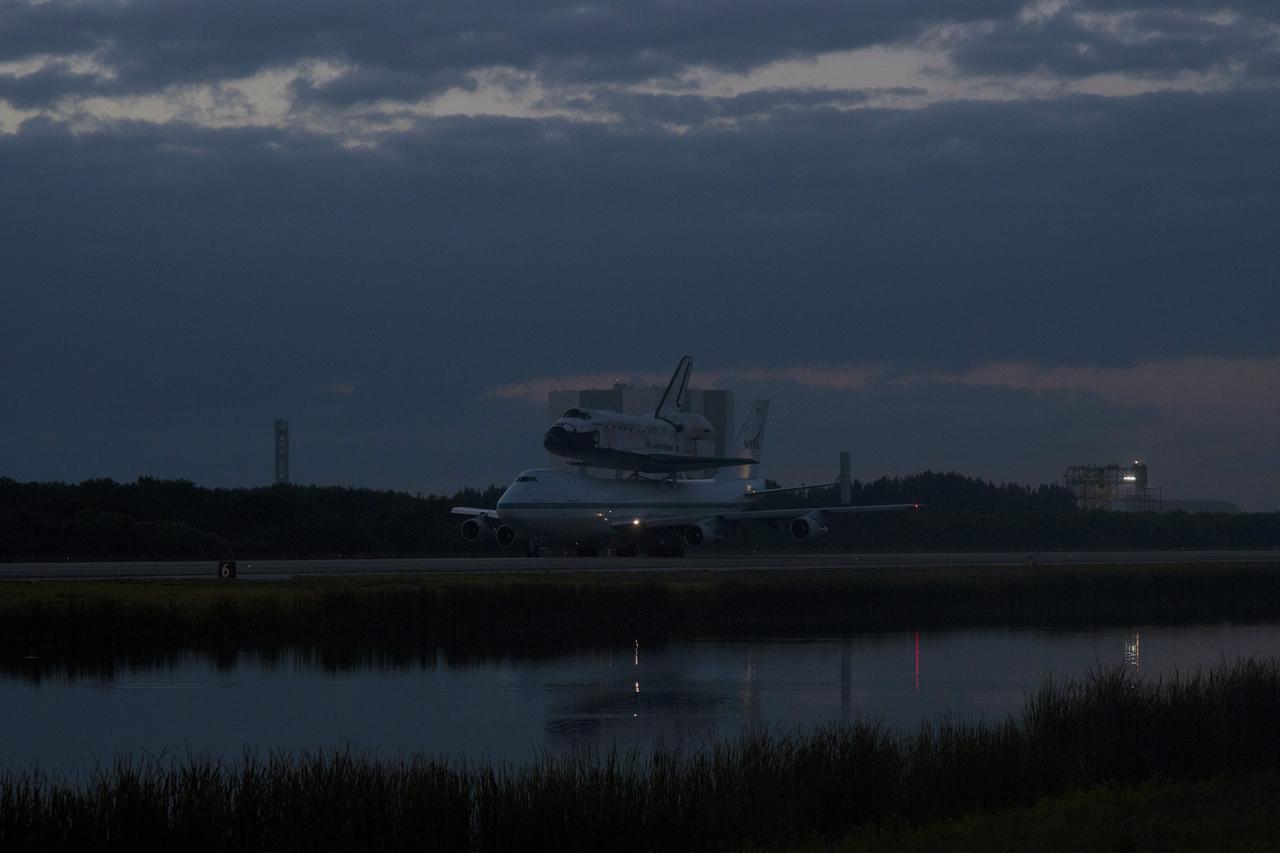 CAPE CANAVERAL, Fla. – In the early morning hours at NASA Kennedy Space Center’s Shuttle Landing Facility in Florida, the Shuttle Carrier Aircraft, or SCA, with space shuttle Discovery secured atop, taxies along the runway on its way for a takeoff on runway 15 at 7 a.m. EDT. The aircraft, known as an SCA, is a Boeing 747 jet, originally manufactured for commercial use, which was modified by NASA to transport the shuttles between destinations on Earth. This SCA, designated NASA 905, is assigned to the remaining ferry missions, delivering the shuttles to their permanent public display sites. NASA 905 is scheduled to ferry Discovery to the Washington Dulles International Airport in Virginia on April 17, after which the shuttle will be placed on display in the Smithsonian’s National Air and Space Museum, Steven F. Udvar-Hazy Center in Chantilly, Va. For more information on the SCA, visit http://www.nasa.gov/centers/dryden/news/FactSheets/FS-013-DFRC.html. For more information on shuttle transition and retirement activities, visit http://www.nasa.gov/transition. Photo credit: NASA/Tim Powers and Rick Wetherington