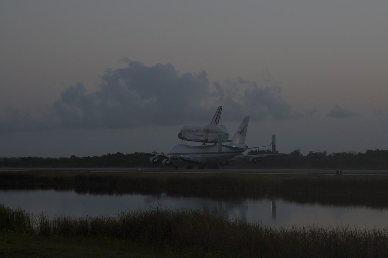 CAPE CANAVERAL, Fla. – In the early morning hours at NASA Kennedy Space Center’s Shuttle Landing Facility in Florida, the Shuttle Carrier Aircraft, or SCA, with space shuttle Discovery secured atop, taxies past the midpoint on its way for a takeoff on runway 15 at 7 a.m. EDT. The aircraft, known as an SCA, is a Boeing 747 jet, originally manufactured for commercial use, which was modified by NASA to transport the shuttles between destinations on Earth. This SCA, designated NASA 905, is assigned to the remaining ferry missions, delivering the shuttles to their permanent public display sites. NASA 905 is scheduled to ferry Discovery to the Washington Dulles International Airport in Virginia on April 17, after which the shuttle will be placed on display in the Smithsonian’s National Air and Space Museum, Steven F. Udvar-Hazy Center in Chantilly, Va. For more information on the SCA, visit http://www.nasa.gov/centers/dryden/news/FactSheets/FS-013-DFRC.html. For more information on shuttle transition and retirement activities, visit http://www.nasa.gov/transition. Photo credit: NASA/Tim Powers and Rick Wetherington