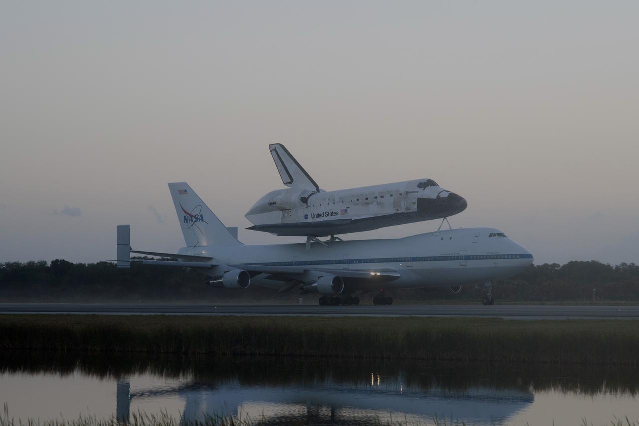 CAPE CANAVERAL, Fla. – In the early morning hours at NASA Kennedy Space Center’s Shuttle Landing Facility in Florida, the Shuttle Carrier Aircraft, or SCA, with space shuttle Discovery secured atop, taxies past the midpoint on its way for a takeoff on runway 15 at 7 a.m. EDT. The aircraft, known as an SCA, is a Boeing 747 jet, originally manufactured for commercial use, which was modified by NASA to transport the shuttles between destinations on Earth. This SCA, designated NASA 905, is assigned to the remaining ferry missions, delivering the shuttles to their permanent public display sites. NASA 905 is scheduled to ferry Discovery to the Washington Dulles International Airport in Virginia on April 17, after which the shuttle will be placed on display in the Smithsonian’s National Air and Space Museum, Steven F. Udvar-Hazy Center in Chantilly, Va. For more information on the SCA, visit http://www.nasa.gov/centers/dryden/news/FactSheets/FS-013-DFRC.html. For more information on shuttle transition and retirement activities, visit http://www.nasa.gov/transition. Photo credit: NASA/Tim Powers and Rick Wetherington