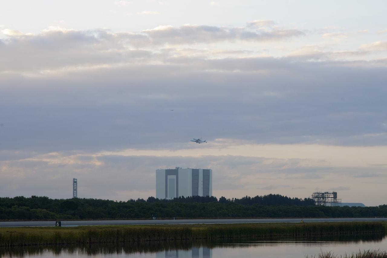 CAPE CANAVERAL, Fla. – The Shuttle Carrier Aircraft transporting space shuttle Discovery to its new home takes off from the Shuttle Landing Facility at NASA’s Kennedy Space Center in Florida at 7 a.m. EDT. The facilities beneath the aircraft are, from left, NASA’s new mobile launcher, the 525-foot-tall Vehicle Assembly Building and the mate/demate device at the landing facility. The aircraft, known as an SCA, is a Boeing 747 jet, originally manufactured for commercial use, which was modified by NASA to transport the shuttles between destinations on Earth. This SCA, designated NASA 905, is assigned to the remaining ferry missions, delivering the shuttles to their permanent public display sites. NASA 905 is scheduled to ferry Discovery to the Washington Dulles International Airport in Virginia on April 17, after which the shuttle will be placed on display in the Smithsonian's National Air and Space Museum Steven F. Udvar-Hazy Center. For more information on the SCA, visit http://www.nasa.gov/centers/dryden/news/FactSheets/FS-013-DFRC.html. For more information on shuttle transition and retirement activities, visit http://www.nasa.gov/transition. Photo credit: NASA/Tim Powers and Rick Wetherington