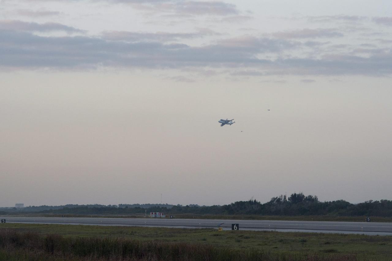 CAPE CANAVERAL, Fla. – The Shuttle Carrier Aircraft transporting space shuttle Discovery to its new home takes off from the Shuttle Landing Facility at NASA’s Kennedy Space Center in Florida at 7 a.m. EDT, accompanied by a NASA helicopter and a T-38 jet. The duo will fly south over Brevard County’s beach communities for residents to get a look at the shuttle before it leaves the Space Coast for the last time. The aircraft, known as an SCA, is a Boeing 747 jet, originally manufactured for commercial use, which was modified by NASA to transport the shuttles between destinations on Earth. This SCA, designated NASA 905, is assigned to the remaining ferry missions, delivering the shuttles to their permanent public display sites. NASA 905 is scheduled to ferry Discovery to the Washington Dulles International Airport in Virginia today, after which the shuttle will be placed on display in the Smithsonian's National Air and Space Museum Steven F. Udvar-Hazy Center. For more information on the SCA, visit http://www.nasa.gov/centers/dryden/news/FactSheets/FS-013-DFRC.html. For more information on shuttle transition and retirement activities, visit http://www.nasa.gov/transition. Photo credit: NASA/Rusty Backer