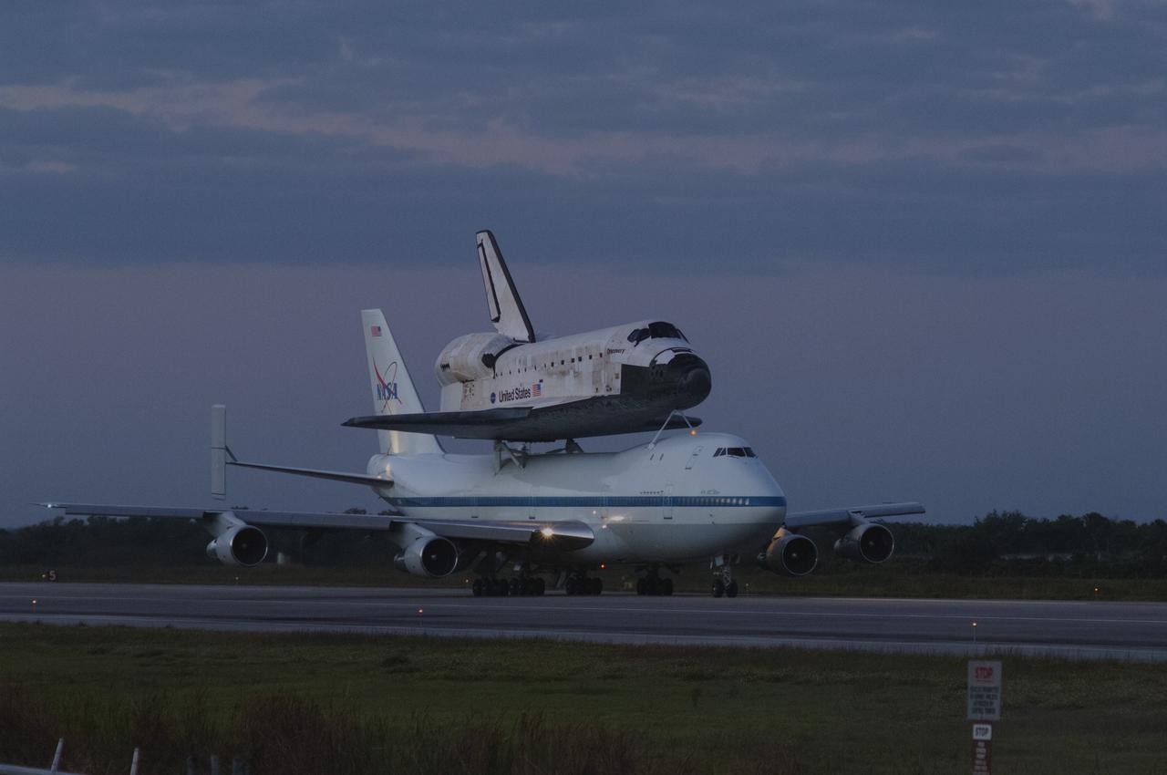 CAPE CANAVERAL, Fla. – Sunrise over the Shuttle Landing Facility at NASA’s Kennedy Space Center in Florida reveals the Shuttle Carrier Aircraft that is transporting space shuttle Discovery to its new home preparing for takeoff.    The aircraft, known as an SCA, is a Boeing 747 jet, originally manufactured for commercial use, which was modified by NASA to transport the shuttles between destinations on Earth. This SCA, designated NASA 905, is assigned to the remaining ferry missions, delivering the shuttles to their permanent public display sites.  NASA 905 is scheduled to ferry Discovery to the Washington Dulles International Airport in Virginia on April 17, after which the shuttle will be placed on display in the Smithsonian's National Air and Space Museum Steven F. Udvar-Hazy Center. For more information on the SCA, visit http://www.nasa.gov/centers/dryden/news/FactSheets/FS-013-DFRC.html. For more information on shuttle transition and retirement activities, visit http://www.nasa.gov/transition. Photo credit: NASA/Rusty Backer