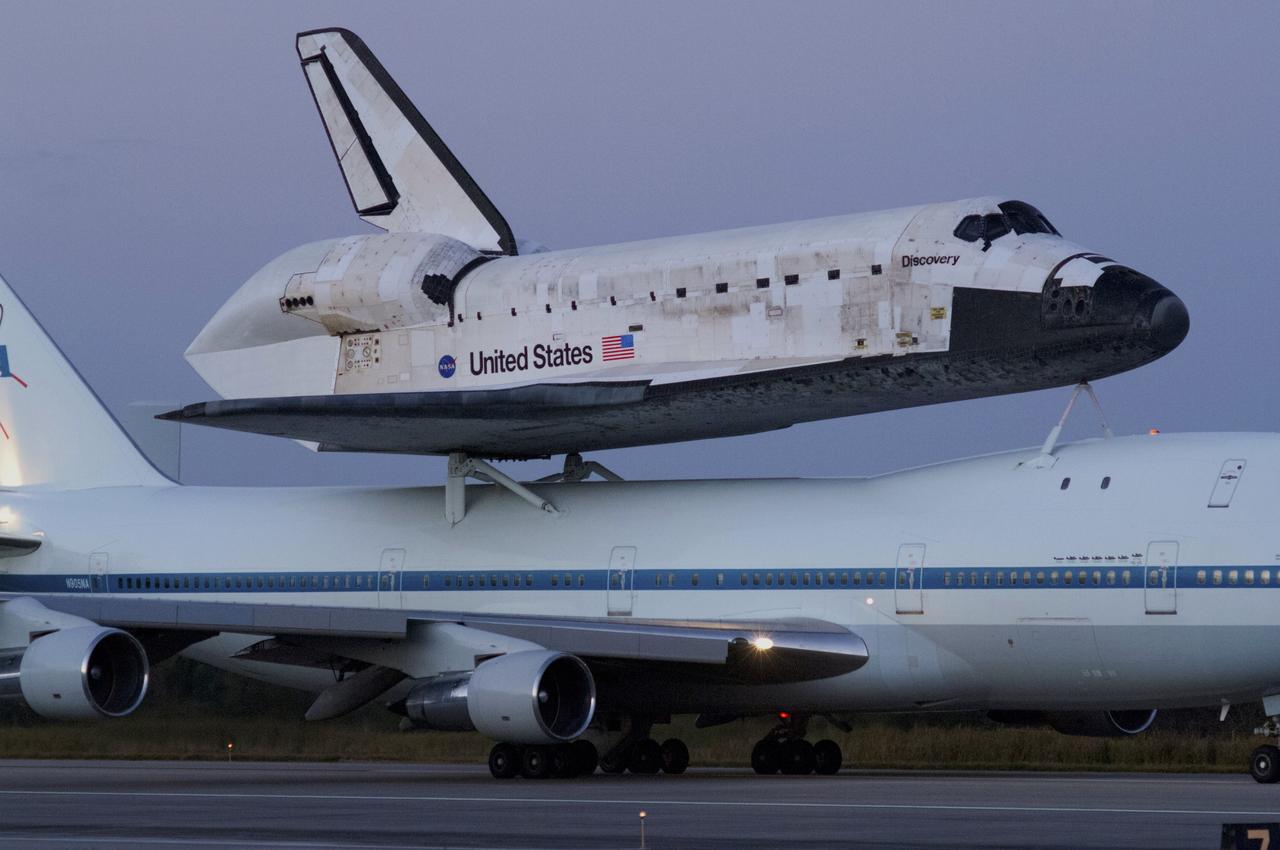 CAPE CANAVERAL, Fla. – Sunrise over the Shuttle Landing Facility at NASA’s Kennedy Space Center in Florida reveals the Shuttle Carrier Aircraft that is transporting space shuttle Discovery to its new home preparing for takeoff.    The aircraft, known as an SCA, is a Boeing 747 jet, originally manufactured for commercial use, which was modified by NASA to transport the shuttles between destinations on Earth. This SCA, designated NASA 905, is assigned to the remaining ferry missions, delivering the shuttles to their permanent public display sites.  NASA 905 is scheduled to ferry Discovery to the Washington Dulles International Airport in Virginia on April 17, after which the shuttle will be placed on display in the Smithsonian's National Air and Space Museum Steven F. Udvar-Hazy Center. For more information on the SCA, visit http://www.nasa.gov/centers/dryden/news/FactSheets/FS-013-DFRC.html. For more information on shuttle transition and retirement activities, visit http://www.nasa.gov/transition. Photo credit: NASA/Rusty Backer