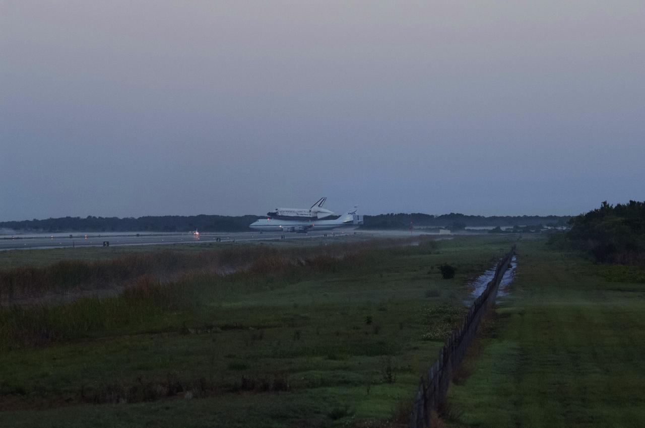 CAPE CANAVERAL, Fla. – Sunrise over the Shuttle Landing Facility at NASA’s Kennedy Space Center in Florida reveals the Shuttle Carrier Aircraft that is transporting space shuttle Discovery to its new home preparing for takeoff.    The aircraft, known as an SCA, is a Boeing 747 jet, originally manufactured for commercial use, which was modified by NASA to transport the shuttles between destinations on Earth. This SCA, designated NASA 905, is assigned to the remaining ferry missions, delivering the shuttles to their permanent public display sites.  NASA 905 is scheduled to ferry Discovery to the Washington Dulles International Airport in Virginia on April 17, after which the shuttle will be placed on display in the Smithsonian's National Air and Space Museum Steven F. Udvar-Hazy Center. For more information on the SCA, visit http://www.nasa.gov/centers/dryden/news/FactSheets/FS-013-DFRC.html. For more information on shuttle transition and retirement activities, visit http://www.nasa.gov/transition. Photo credit: NASA/Rusty Backer