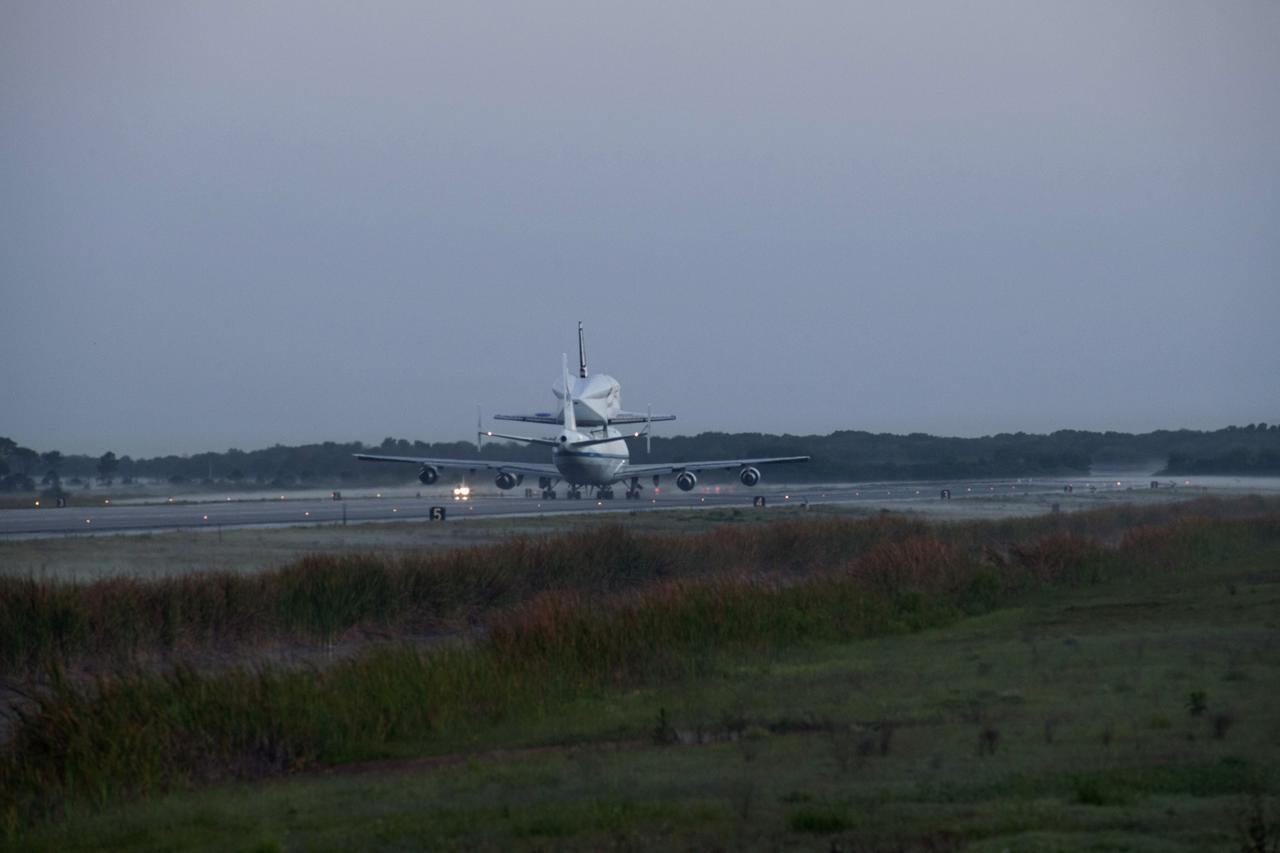 CAPE CANAVERAL, Fla. – Daybreak at the Shuttle Landing Facility at NASA’s Kennedy Space Center in Florida finds the Shuttle Carrier Aircraft that is transporting space shuttle Discovery to its new home taxiing down the runway, preparing for takeoff. The aircraft, known as an SCA, is a Boeing 747 jet, originally manufactured for commercial use, which was modified by NASA to transport the shuttles between destinations on Earth. This SCA, designated NASA 905, is assigned to the remaining ferry missions, delivering the shuttles to their permanent public display sites. NASA 905 is scheduled to ferry Discovery to the Washington Dulles International Airport in Virginia on April 17, after which the shuttle will be placed on display in the Smithsonian's National Air and Space Museum Steven F. Udvar-Hazy Center. For more information on the SCA, visit http://www.nasa.gov/centers/dryden/news/FactSheets/FS-013-DFRC.html. For more information on shuttle transition and retirement activities, visit http://www.nasa.gov/transition. Photo credit: NASA/Rusty Backer