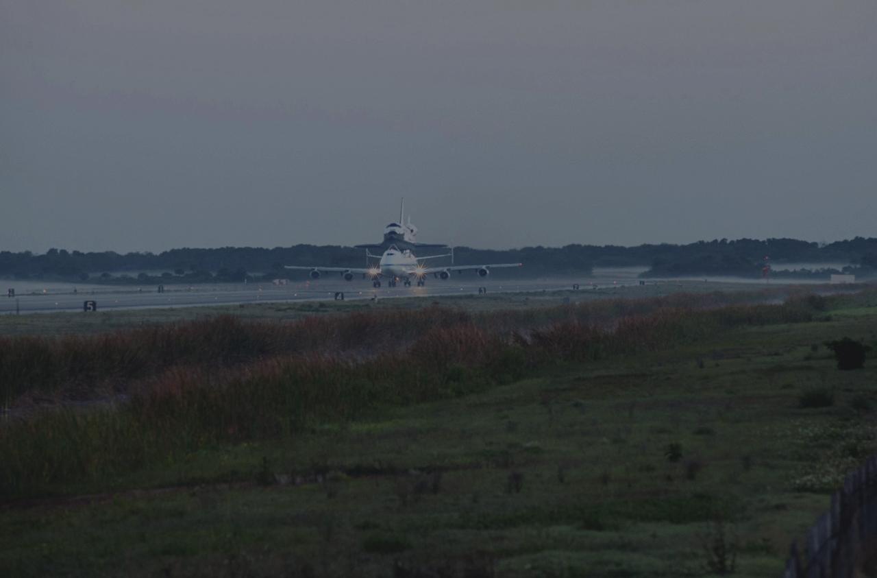 CAPE CANAVERAL, Fla. – Daybreak at the Shuttle Landing Facility at NASA’s Kennedy Space Center in Florida finds the Shuttle Carrier Aircraft that is transporting space shuttle Discovery to its new home taxiing down the runway, preparing for takeoff. The aircraft, known as an SCA, is a Boeing 747 jet, originally manufactured for commercial use, which was modified by NASA to transport the shuttles between destinations on Earth. This SCA, designated NASA 905, is assigned to the remaining ferry missions, delivering the shuttles to their permanent public display sites. NASA 905 is scheduled to ferry Discovery to the Washington Dulles International Airport in Virginia on April 17, after which the shuttle will be placed on display in the Smithsonian's National Air and Space Museum Steven F. Udvar-Hazy Center. For more information on the SCA, visit http://www.nasa.gov/centers/dryden/news/FactSheets/FS-013-DFRC.html. For more information on shuttle transition and retirement activities, visit http://www.nasa.gov/transition. Photo credit: NASA/Rusty Backer