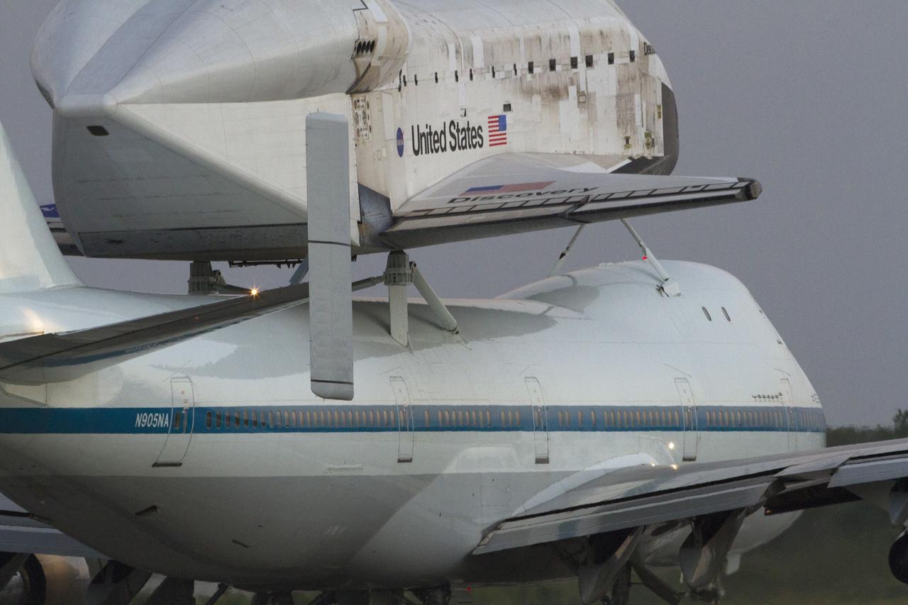 CAPE CANAVERAL, Fla. - Space shuttle Discovery, mounted atop the Shuttle Carrier Aircraft, taxies down the runway at NASA's Kennedy Space Center in Florida. The duo departed Kennedy' s runway 15 at 7 a.m. EDT.    The aircraft, known as an SCA, is a Boeing 747 jet, originally manufactured for commercial use, which was modified by NASA to transport the shuttles between destinations on Earth. This SCA, designated NASA 905, is assigned to the remaining ferry  missions, delivering the shuttles to their permanent public display sites. NASA 905 carried Discovery to the Washington Dulles International Airport in Virginia on April 17, after which the shuttle will be placed on display in the Smithsonian's National Air and Space Museum, Steven F. Udvar-Hazy Center in Chantilly,  Va. For more information on the SCA, visit http://www.nasa.gov/centers/dryden/news/FactSheets/FS-  013-DFRC.html. For more information on shuttle transition and retirement activities, visit  http://www .nasa.gov/transition. Photo credit: NASA/Rusty Backer