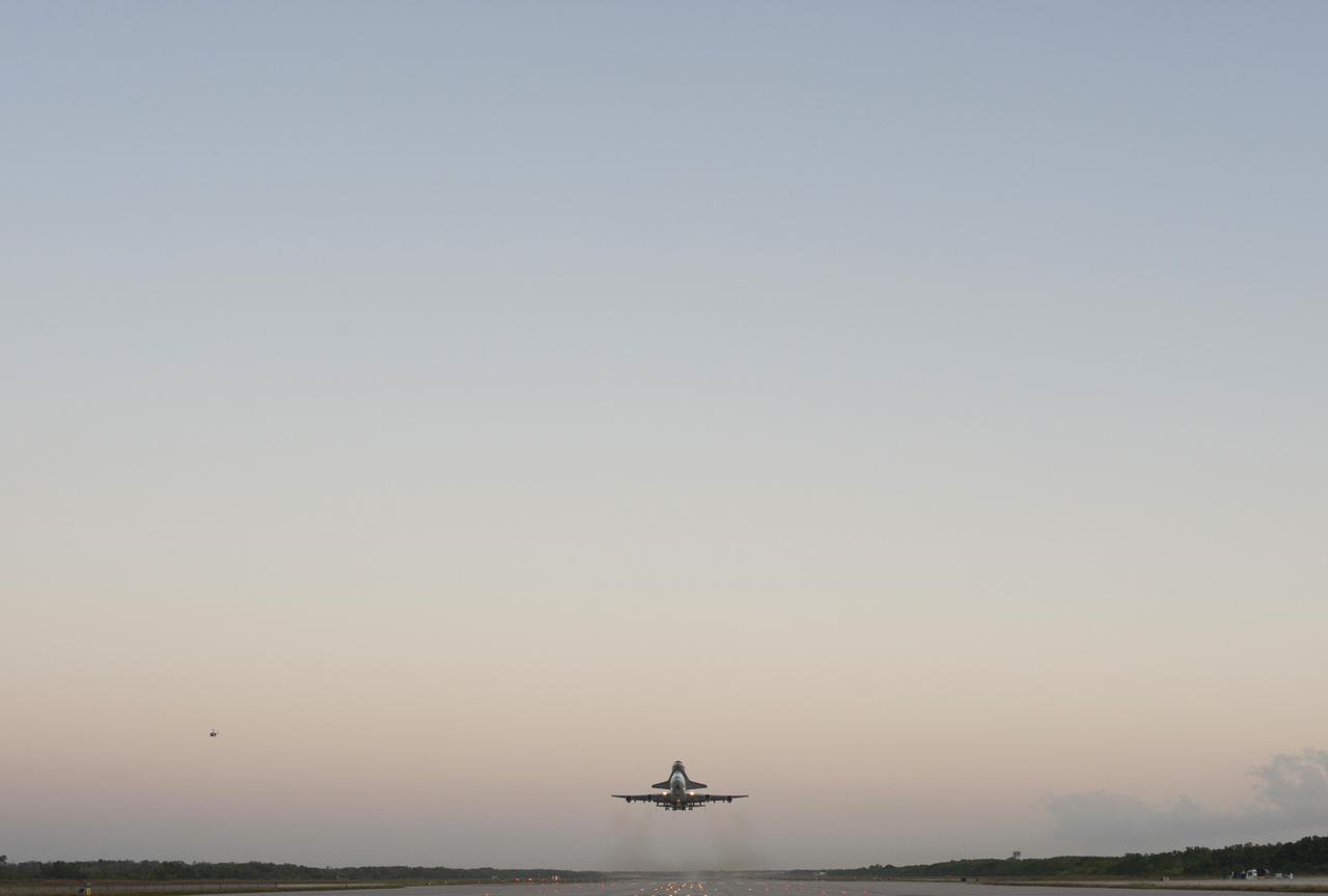 CAPE CANAVERAL, Fla. - Sunrise paints the sky above NASA's Kennedy Space Center in Florida as the Shuttle Carrier Aircraft transporting space shuttle Discovery takes off from runway 15 at 7 a.m. EDT.      The duo is beginning its ferry flight to the Washington Dulles International Airport in Virginia that also includes a flyby of the Space Coast and Washington, D.C. Discovery is leaving Kennedy after more than 28 years of service beginning with its arrival on the space coast Nov. 9, 1983. Discovery is set to move to the Smithsonian's National Air and Space Museum, Steven F. Udvar-Hazy Center in Chantilly, Va., on April 19 where it will be placed on public display.  For more information on the Shuttle Carrier Aircraft, visit http://www.nasa .gov/centers/dryden/news/FactSheets/FS-013- DFRC.html. For more information on shuttle transition and retirement activities, visit http://www.nasa.gov/transition. Photo credit: NASA/Tim Powers and Tim Terry