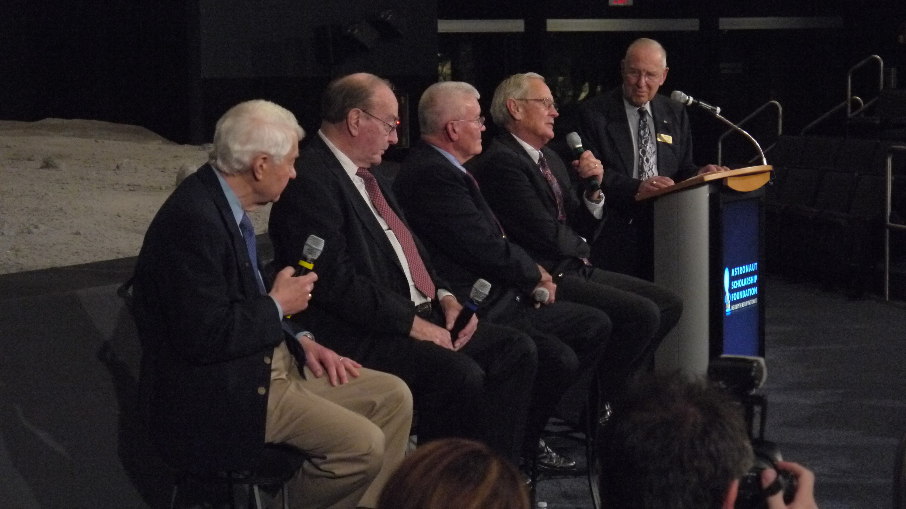 Group of Apollo astronauts seated for an anniversary event