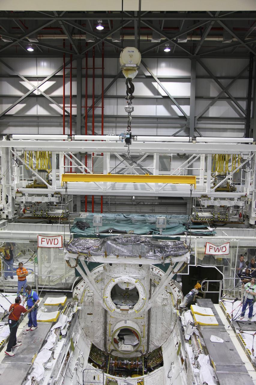 CAPE CANAVERAL, Fla. – In Orbiter Processing Facility-2 at NASA's Kennedy Space Center in Florida, a crane lifts the airlock from space shuttle Endeavour’s payload bay. The airlock was the connecting point between the shuttle and the International Space Station. Endeavour is being prepared for public display at the California Science Center in Los Angeles. Over the course of its 19-year career, Endeavour spent 299 days in space during 25 missions. For more information, visit http://www.nasa.gov/transition. Photo credit: NASA/Frankie Martin