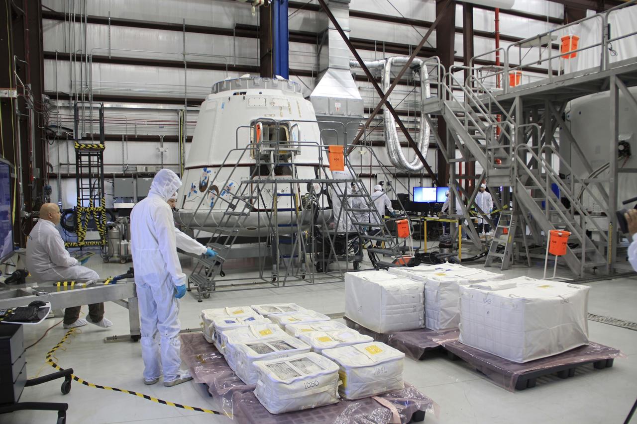 CAPE CANAVERAL, Fla. – In a processing hangar at Space Launch Complex-40 on Cape Canaveral Air Force Station in Florida, preparations are under way to load cargo into the Space Exploration Technologies Dragon capsule in preparation for its scheduled April 30 liftoff aboard a Falcon 9 rocket. Known as SpaceX, the launch will be the company's second demonstration test flight for NASA's Commercial Orbital Transportation Services program, or COTS. During the flight, the capsule will conduct a series of checkout procedures to test and prove its systems, including rendezvous and berthing with the International Space Station. The cargo includes food and provisions for the station’s Expedition crews, such as clothing, batteries, and computer equipment. Under COTS, NASA has partnered with two private companies to launch cargo safely to the station. For more information, visit http://www.nasa.gov/spacex. Photo credit: NASA/Jim Grossmann