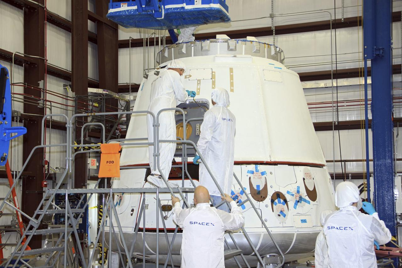 CAPE CANAVERAL, Fla. – In a processing hangar at Space Launch Complex-40 on Cape Canaveral Air Force Station in Florida, the hatch of the Space Exploration Technologies Dragon capsule has been closed following stowage of cargo in preparation for its scheduled April 30 liftoff aboard a Falcon 9 rocket. Known as SpaceX, the launch will be the company's second demonstration test flight for NASA's Commercial Orbital Transportation Services program, or COTS. During the flight, the capsule will conduct a series of checkout procedures to test and prove its systems, including rendezvous and berthing with the International Space Station. The cargo includes food and provisions for the station’s Expedition crews, such as clothing, batteries, and computer equipment. Under COTS, NASA has partnered with two private companies to launch cargo safely to the station. For more information, visit http://www.nasa.gov/spacex. Photo credit: NASA/Jim Grossmann