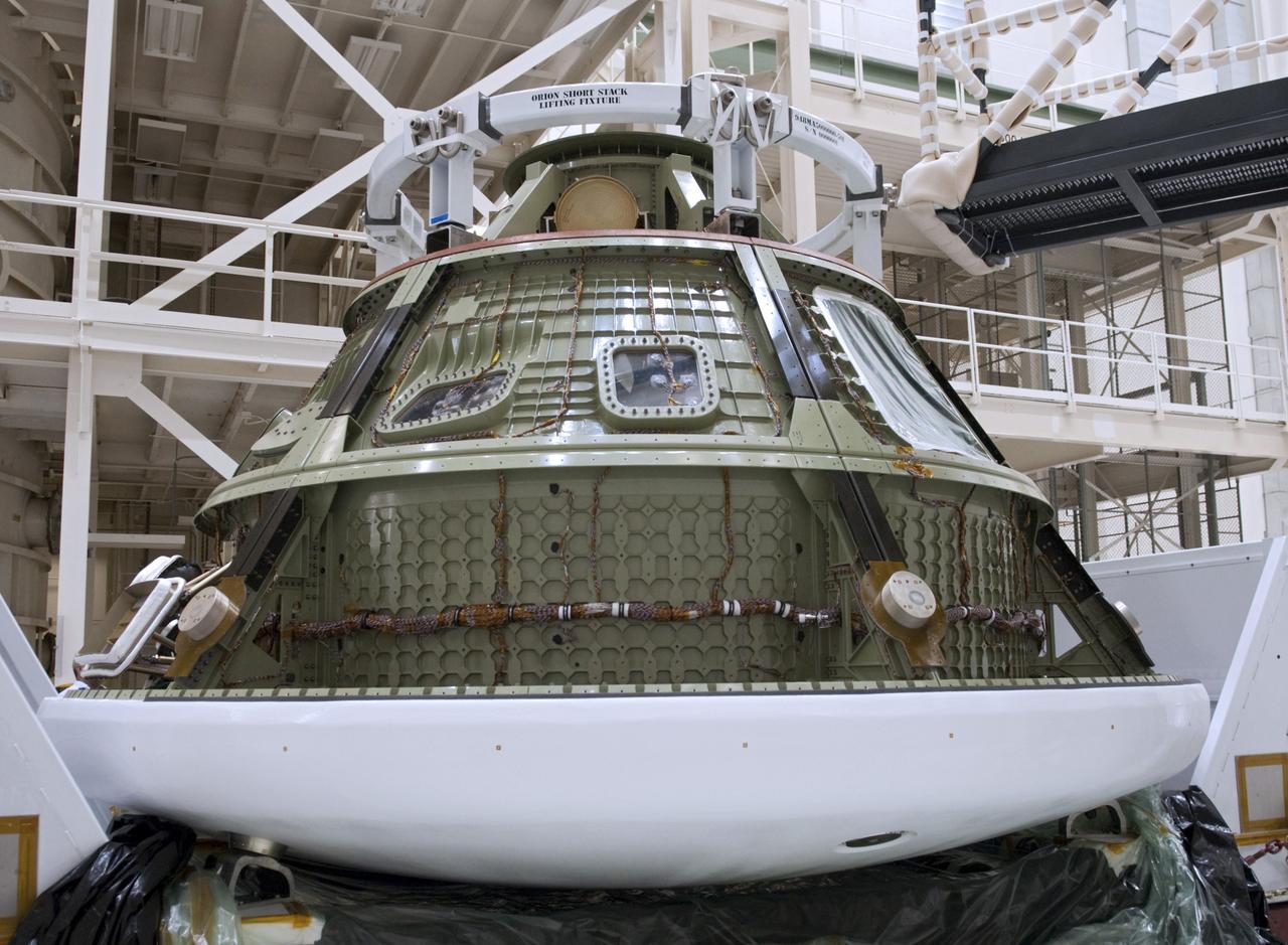 CAPE CANAVERAL, Fla. -- Lockheed Martin crews have unpacked the Orion ground test vehicle in the Operations and Checkout O&C Facility at NASA's Kennedy Space Center in Florida. The vehicle traveled more than 1,800 miles from the company's Waterton Facility near Denver where it successfully completed a series of rigorous tests that simulated launch and spaceflight environments. The ground test vehicle will be used for pathfinding operations in the O&C, including simulated manufacturing and assembly procedures. After those operations are completed, new backshell panels will be installed on the ground test vehicle at the O&C prior to the vehicle’s trek to NASA's Langley Research Center in Virginia for splashdown testing at the agency's Hydro Impact Basin.    Launching atop NASA's heavy-lift Space Launch System SLS, which also is under development, the Orion Multi-Purpose Crew Vehicle MPCV will serve as the exploration vehicle that will carry astronaut crews beyond low Earth orbit. It also will provide emergency abort capabilities, sustain the crew during space travel and provide safe re-entry from deep space return velocities. For more information, visit www.nasa.gov/orion. Photo credit: Charisse Nahser