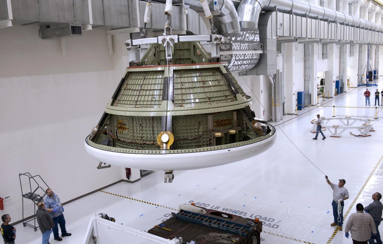 CAPE CANAVERAL, Fla. -- Lockheed Martin crews remove the Orion ground test vehicle from its packaging in the Operations and Checkout O&C Facility at NASA's Kennedy Space Center in Florida. The vehicle traveled more than 1,800 miles from the company's Waterton Facility near Denver where it successfully completed a series of rigorous tests that simulated launch and spaceflight environments. The ground test vehicle will be used for pathfinding operations in the O&C, including simulated manufacturing and assembly procedures. After those operations are completed, new backshell panels will be installed on the ground test vehicle at the O&C prior to the vehicle’s trek to NASA's Langley Research Center in Virginia for splashdown testing at the agency's Hydro Impact Basin.        Launching atop NASA's heavy-lift Space Launch System SLS, which also is under development, the Orion Multi-Purpose Crew Vehicle MPCV will serve as the exploration vehicle that will carry astronaut crews beyond low Earth orbit. It also will provide emergency abort capabilities, sustain the crew during space travel and provide safe re-entry from deep space return velocities. For more information, visit www.nasa.gov/orion. Photo credit: Charisse Nahser