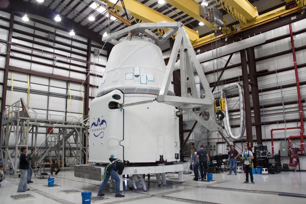 CAPE CANAVERAL, Fla. – In a processing facility at Space Launch Complex-40 on Cape Canaveral Air Force Station in Florida, Space Exploration Technologies technicians prepare to rotate the Dragon capsule into a horizontal position for mating with the second stage of the company’s Falcon 9 rocket. Known as SpaceX, the launch will be the company's second demonstration test flight for NASA's Commercial Orbital Transportation Services program, or COTS. During the flight, the capsule will conduct a series of check-out procedures to test and prove its systems, including rendezvous and berthing with the International Space Station. If the capsule performs as planned, the NanoRacks-CubeLabs Module-9 experiments and other cargo aboard Dragon will be transferred to the station. The cargo includes food, water and provisions for the station’s Expedition crews, such as clothing, batteries and computer equipment. Under COTS, NASA has partnered with two private companies to provide resupply missions to the station. The launch is scheduled for 9:38 a.m. EDT on May 7. For more information, visit http://www.nasa.gov/spacex. Photo credit: NASA/Jim Grossmann
