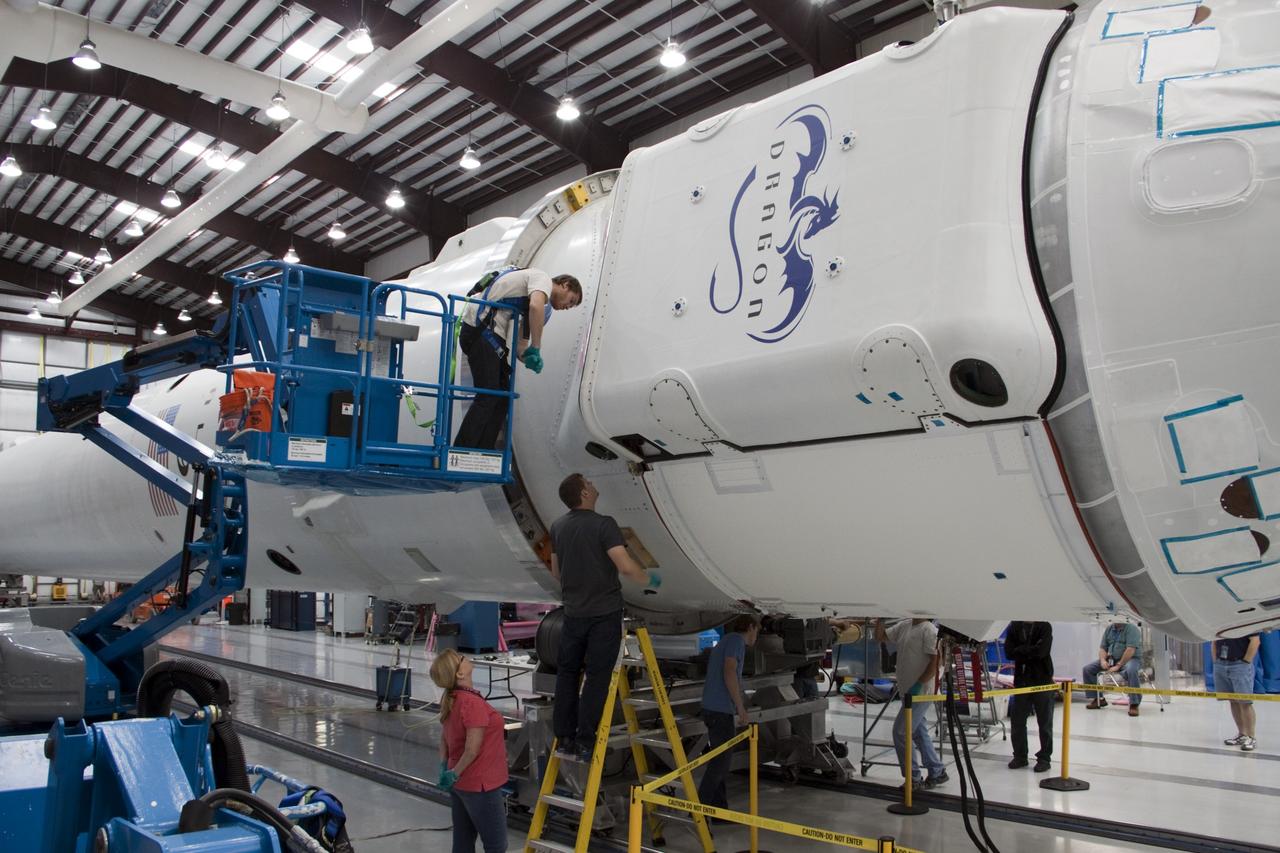CAPE CANAVERAL, Fla. – In a processing facility at Space Launch Complex-40 on Cape Canaveral Air Force Station in Florida, Space Exploration Technologies technicians attach the Dragon capsule to the second stage of the company’s Falcon 9 rocket. Known as SpaceX, the launch will be the company's second demonstration test flight for NASA's Commercial Orbital Transportation Services program, or COTS. During the flight, the capsule will conduct a series of check-out procedures to test and prove its systems, including rendezvous and berthing with the International Space Station. If the capsule performs as planned, the NanoRacks-CubeLabs Module-9 experiments and other cargo aboard Dragon will be transferred to the station. The cargo includes food, water and provisions for the station’s Expedition crews, such as clothing, batteries and computer equipment. Under COTS, NASA has partnered with two private companies to provide resupply missions to the station. The launch is scheduled for 9:38 a.m. EDT on May 7. For more information, visit http://www.nasa.gov/spacex. Photo credit: NASA/Jim Grossmann