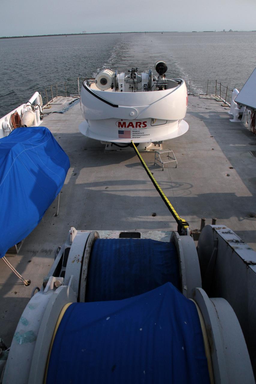 CAPE CANAVERAL, Fla. – NASA’s Freedom Star boat heads for the open waters of the Atlantic Ocean after departing from Port Canaveral in Florida. NASA’s Mobile Aerospace Reconnaissance System, or MARS, is secured aboard Freedom Star for a day of testing.    MARS, run by NASA’s Langley Research Center in Hampton, Va., with its spatial, hyperspectral, thermal, and directed energy capabilities will be used for thermal imaging testing for the upcoming SpaceX Falcon 9 and Dragon capsule test flight to the International Space Station. During today’s test, the MARS X-band radar and kineto tracking mount KTM were tested to ensure that they were synchronized to receive a rocket launch feed. The radar was used to identify an object to see if the KTM could lock on to and track it. The MARS team performed maintenance on the system, confirmed communications links, and tested the design of the mounting system and environmental enclosure. Photo credit: NASA/Cory Huston