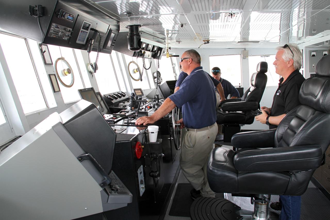 CAPE CANAVERAL, Fla. – Aboard NASA’s Freedom Star boat, from left, Boatswain Allan Gravina at the wheel, Captain Mike Nicholas hidden, Aerospace Technician Darin Schuster and Marine Operations Manager Joe Chaput, all with United Space Alliance, monitor the progress as NASA’s Mobile Aerospace Reconnaissance System, or MARS, secured on the boat, is being prepared for a day of testing in the Atlantic Ocean off the coast of Port Canaveral in Florida.    MARS, run by NASA’s Langley Research Center in Hampton, Va., with its spatial, hyperspectral, thermal, and directed energy capabilities will be used for thermal imaging testing for the upcoming SpaceX Falcon 9 and Dragon capsule test flight to the International Space Station. During today’s test, the MARS X-band radar and kineto tracking mount KTM were tested to ensure that they were synchronized to receive a rocket launch feed. The radar was used to identify an object to see if the KTM could lock on to and track it. The MARS team performed maintenance on the system, confirmed communications links, and tested the design of the mounting system and environmental enclosure. Photo credit: NASA/Cory Huston
