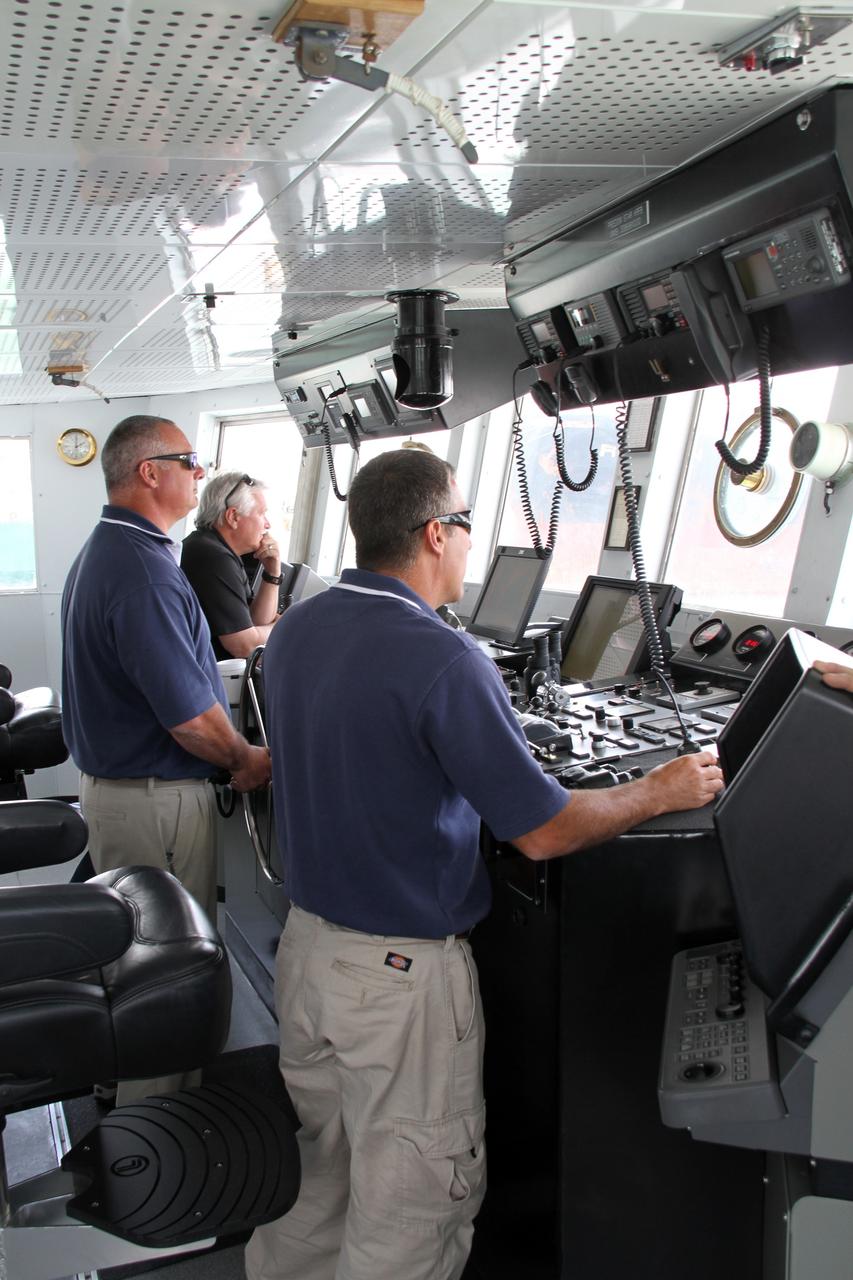 CAPE CANAVERAL, Fla. – Aboard NASA’s Freedom Star boat, Captain Mike Nicholas in foreground, Boatswain Allan Gravina at the wheel, and Marine Operations Manager Joe Chaput, all with United Space Alliance, monitor the progress as NASA’s Mobile Aerospace Reconnaissance System, or MARS, secured on the boat, is being prepared for a day of testing in the Atlantic Ocean off the coast of Port Canaveral in Florida.    MARS, run by NASA’s Langley Research Center in Hampton, Va., with its spatial, hyperspectral, thermal, and directed energy capabilities will be used for thermal imaging testing for the upcoming SpaceX Falcon 9 and Dragon capsule test flight to the International Space Station. During today’s test, the MARS X-band radar and kineto tracking mount KTM were tested to ensure that they were synchronized to receive a rocket launch feed. The radar was used to identify an object to see if the KTM could lock on to and track it. The MARS team performed maintenance on the system, confirmed communications links, and tested the design of the mounting system and environmental enclosure. Photo credit: NASA/Cory Huston