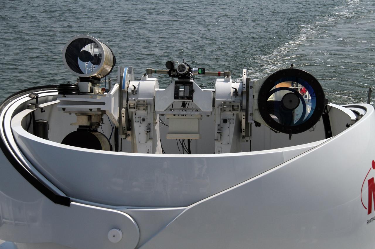 CAPE CANAVERAL, Fla. – Aboard NASA’s Freedom Star boat in the Atlantic Ocean off the coast of Port Canaveral in Florida, the covering around NASA’s Mobile Aerospace Reconnaissance System, or MARS, has been removed. MARS is being prepared for a day of testing in the Atlantic Ocean.      MARS, run by NASA’s Langley Research Center in Hampton, Va., with its spatial, hyperspectral, thermal, and directed energy capabilities will be used for thermal imaging testing for the upcoming SpaceX Falcon 9 and Dragon capsule test flight to the International Space Station. During today’s test, the MARS X-band radar and kineto tracking mount KTM were tested to ensure that they were synchronized to receive a rocket launch feed. The radar was used to identify an object to see if the KTM could lock on to and track it. The MARS team performed maintenance on the system, confirmed communications links, and tested the design of the mounting system and environmental enclosure. Photo credit: NASA/Cory Huston