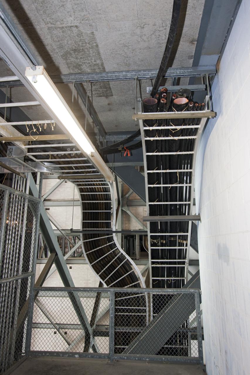 CAPE CANAVERAL, Fla. – At NASA’s Kennedy Space Center in Florida, cable is being pulled from the cable trays lining the walls of high bay 3 in the Vehicle Assembly Building, or VAB, as part of a centerwide refurbishment initiative under the Ground Systems Development and Operations GSDO Program.        The cable replacement project is under way in high bays 1 and 3 on the east side of the building, facing Launch Complex 39’s pads A and B.  Approximately 150 miles of existing Apollo/shuttle era cabling is being removed to make room for installation of state-of-the-art command, communication and control systems that will be needed by future users to perform vehicle testing and verification prior to rollout to the launch pad.  For more information, visit http://go.nasa.gov/groundsystems.  Photo credit: NASA/Jim Grossmann