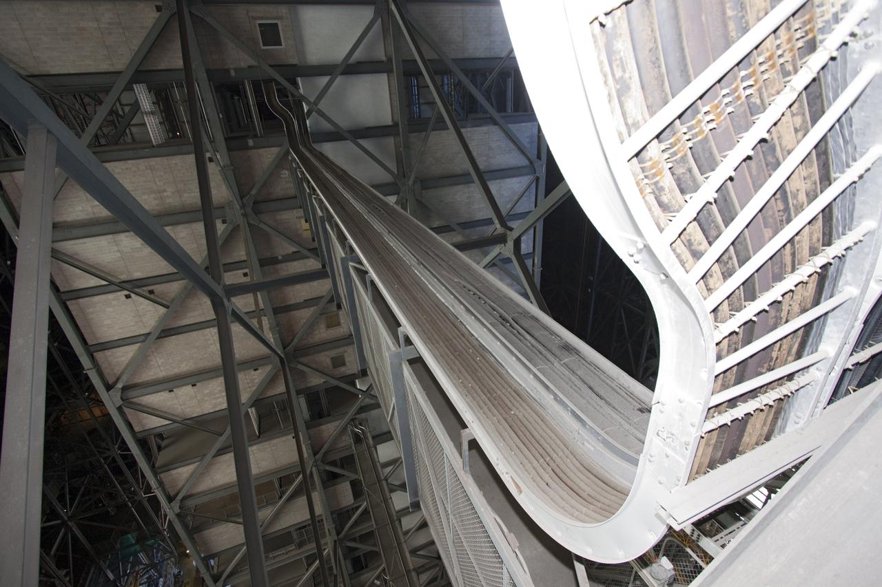CAPE CANAVERAL, Fla. – At NASA’s Kennedy Space Center in Florida, cable trays wind their way along the grating in high bay 3 in the Vehicle Assembly Building, or VAB, during part of a centerwide refurbishment initiative under the Ground Systems Development and Operations GSDO Program.      The cable replacement project is under way in high bays 1 and 3 on the east side of the building, facing Launch Complex 39’s pads A and B.  Approximately 150 miles of existing Apollo/shuttle era cabling is being removed to make room for installation of state-of-the-art command, communication and control systems that will be needed by future users to perform vehicle testing and verification prior to rollout to the launch pad.  For more information, visit http://go.nasa.gov/groundsystems.  Photo credit: NASA/Jim Grossmann