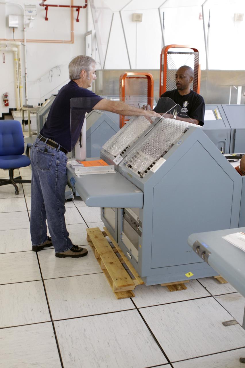 CAPE CANAVERAL, Fla. – Inside the Launch Control Center at NASA’s Kennedy Space Center in Florida, workers prepare to remove the Public Affairs Office console from Firing Room 3. The console will be moved to the Kennedy Space Center Visitor Complex in Florida and will be preserved for use in the space shuttle Atlantis display. During the 30-year history of NASA’s space shuttle launches, Public Affairs Officers sat at the console to provide commentary during shuttle tanking and launches. Photo credit: NASA/Glenn Benson
