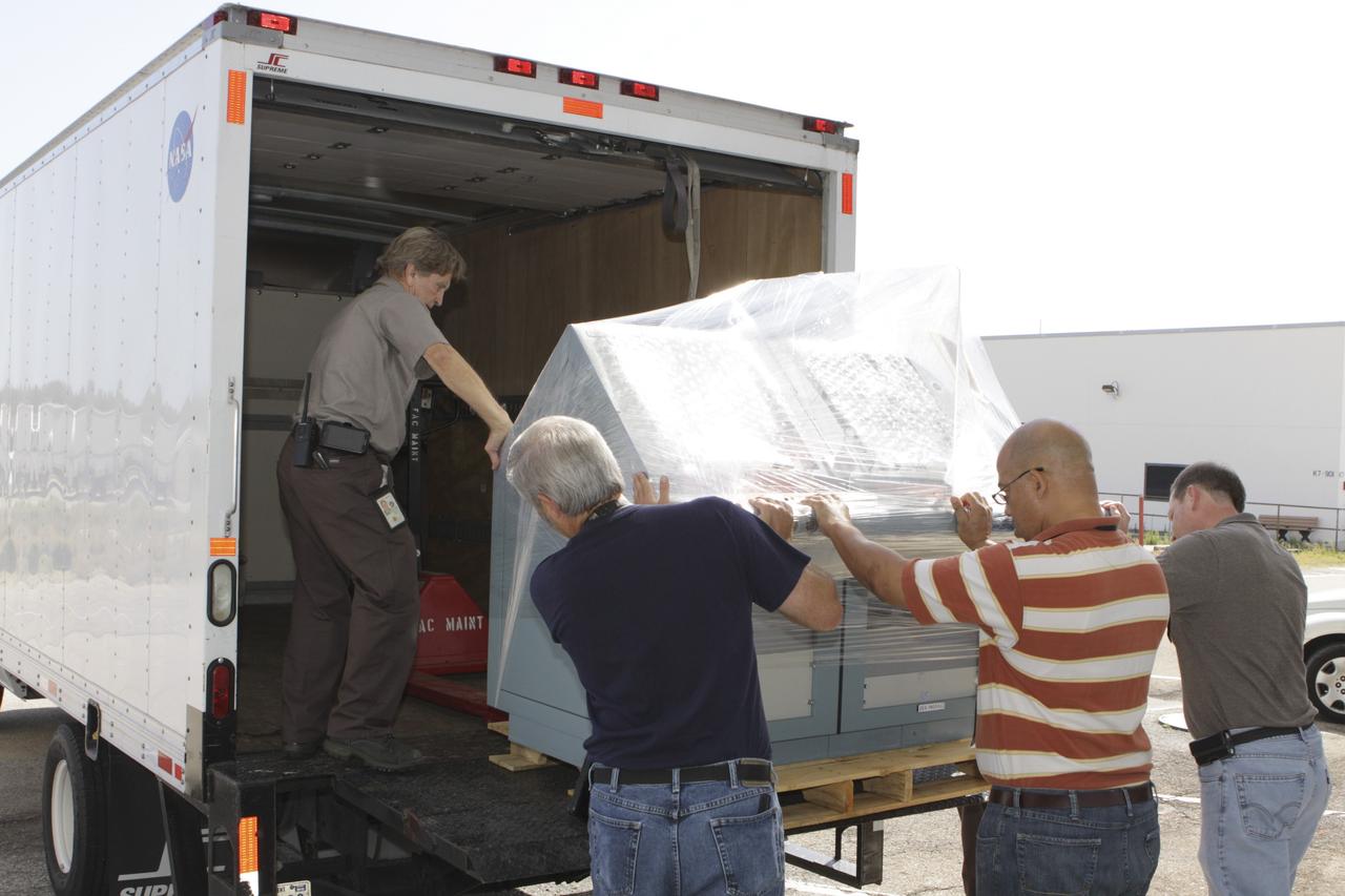 CAPE CANAVERAL, Fla. –At NASA’s Kennedy Space Center in Florida, workers help load the Public Affairs Office console and chairs from Launch Control Center Firing Room 3 onto a truck. The console will be moved to the Kennedy Space Center Visitor Complex in Florida and will be preserved for use in the space shuttle Atlantis display. During the 30-year history of NASA’s space shuttle launches, Public Affairs Officers sat at the console to provide commentary during shuttle tanking and launches. Photo credit: NASA/Glenn Benson