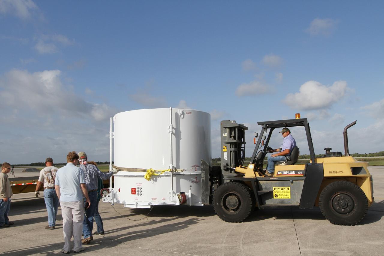 CAPE CANAVERAL, Fla. – A forklift operator moves NASA's Radiation Belt Storm Probe B, enclosed in a protective shipping container, toward a flatbed truck at the Shuttle Landing Facility at NASA’s Kennedy Space Center in Florida. The twin RBSP spacecraft will be transported to the Astrotech payload processing facility near Kennedy Space Center where Applied Physics Laboratory technicians will begin spacecraft testing and prelaunch preparations.        The RBSP mission will help us understand the sun’s influence on Earth and near-Earth space by studying the Earth’s radiation belts on various scales of space and time. The RBSP instruments will provide the measurements needed to characterize and quantify the plasma processes that produce very energetic ions and relativistic electrons. The mission is part of NASA’s broader Living With a Star Program that was conceived to explore fundamental processes that operate throughout the solar system, and in particular those that generate hazardous space weather effects in the vicinity of Earth and phenomena that could impact solar system exploration. RBSP is scheduled to begin its mission of exploration of Earth's Van Allen Radiation Belts and the extremes of space weather after launch. Launch aboard a United Launch Alliance Atlas V rocket is scheduled for August 23.  For more information, visit http://www.nasa.gov/rbsp.  Photo credit: NASA/Kim Shiflett