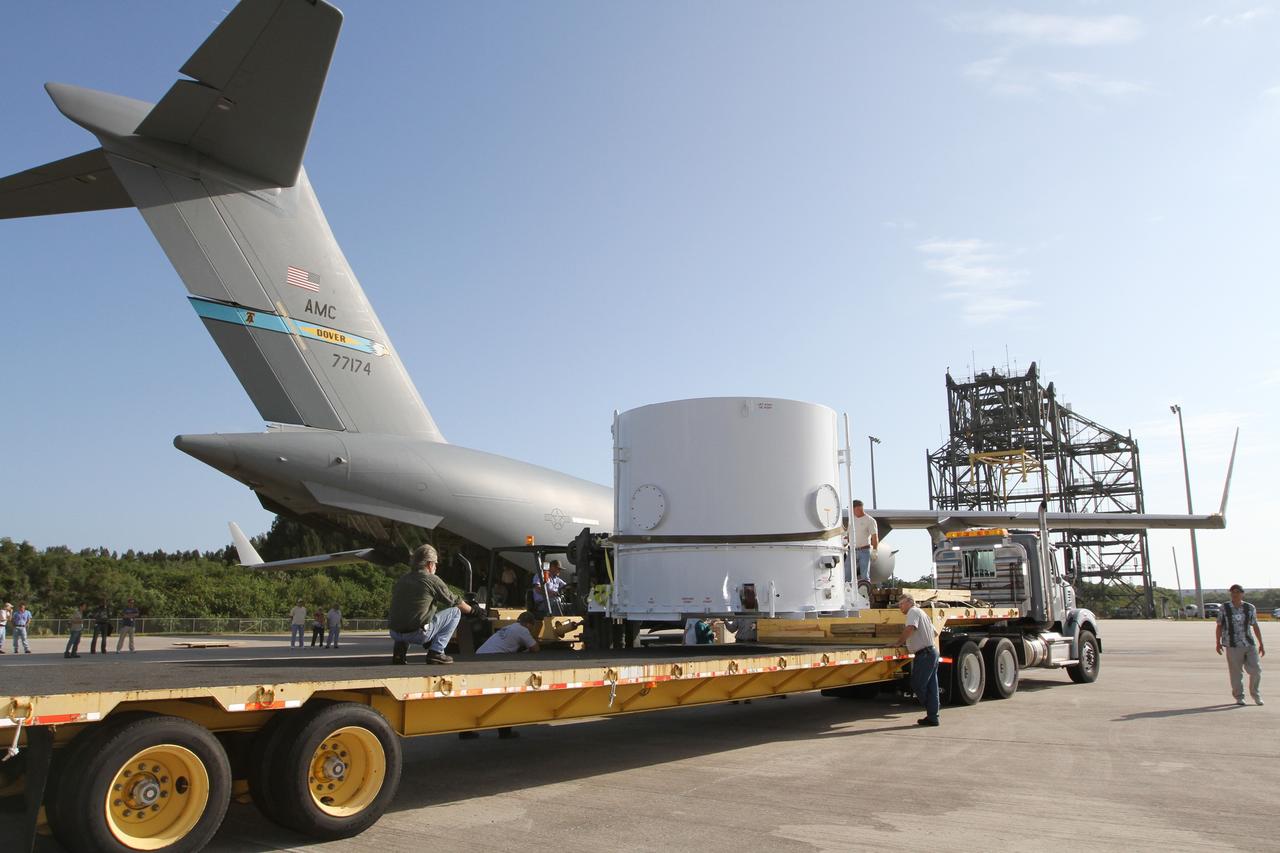 CAPE CANAVERAL, Fla. – Workers position NASA's Radiation Belt Storm Probe B, enclosed in a protective shipping container, onto a flatbed truck at the Shuttle Landing Facility at NASA’s Kennedy Space Center in Florida. The twin RBSP spacecraft will be transported to the Astrotech payload processing facility near Kennedy Space Center where Applied Physics Laboratory technicians will begin spacecraft testing and prelaunch preparations.      The RBSP mission will help us understand the sun’s influence on Earth and near-Earth space by studying the Earth’s radiation belts on various scales of space and time. The RBSP instruments will provide the measurements needed to characterize and quantify the plasma processes that produce very energetic ions and relativistic electrons. The mission is part of NASA’s broader Living With a Star Program that was conceived to explore fundamental processes that operate throughout the solar system, and in particular those that generate hazardous space weather effects in the vicinity of Earth and phenomena that could impact solar system exploration. RBSP is scheduled to begin its mission of exploration of Earth's Van Allen Radiation Belts and the extremes of space weather after launch. Launch aboard a United Launch Alliance Atlas V rocket is scheduled for August 23.  For more information, visit http://www.nasa.gov/rbsp.  Photo credit: NASA/Kim Shiflett