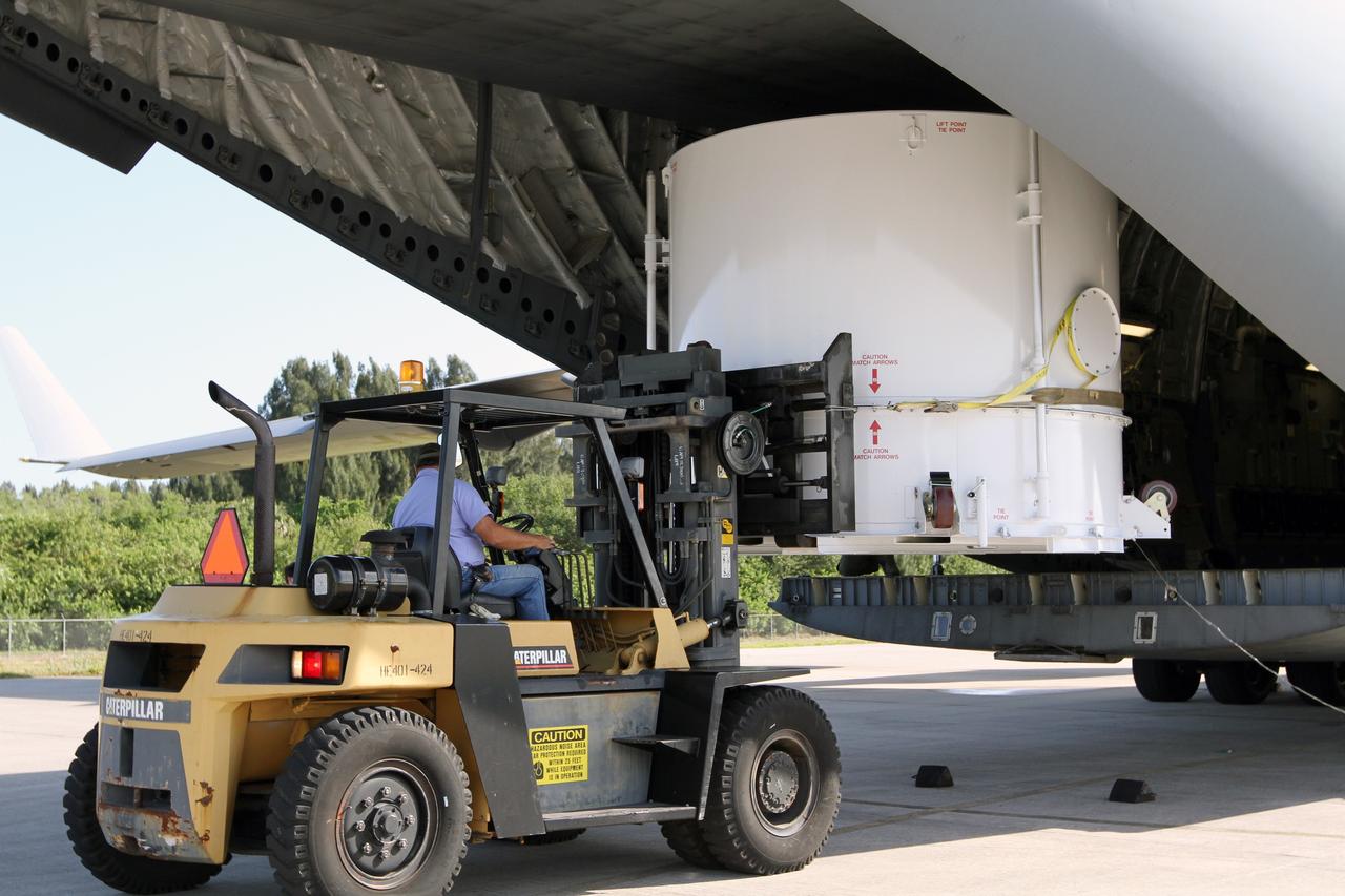CAPE CANAVERAL, Fla. – A forklift operator lowers NASA's Radiation Belt Storm Probe A, enclosed in a protective shipping container, from the cargo bay of a U.S. Air Force C-17 airplane to the tarmac at the Shuttle Landing Facility at NASA’s Kennedy Space Center in Florida. The RBSP mission will help us understand the sun’s influence on Earth and near-Earth space by studying the Earth’s radiation belts on various scales of space and time. The RBSP instruments will provide the measurements needed to characterize and quantify the plasma processes that produce very energetic ions and relativistic electrons. The mission is part of NASA’s broader Living With a Star Program that was conceived to explore fundamental processes that operate throughout the solar system, and in particular those that generate hazardous space weather effects in the vicinity of Earth and phenomena that could impact solar system exploration. RBSP is scheduled to begin its mission of exploration of Earth's Van Allen Radiation Belts and the extremes of space weather after launch. Launch aboard a United Launch Alliance Atlas V rocket is scheduled for August 23. For more information, visit http://www.nasa.gov/rbsp. Photo credit: NASA/Kim Shiflett