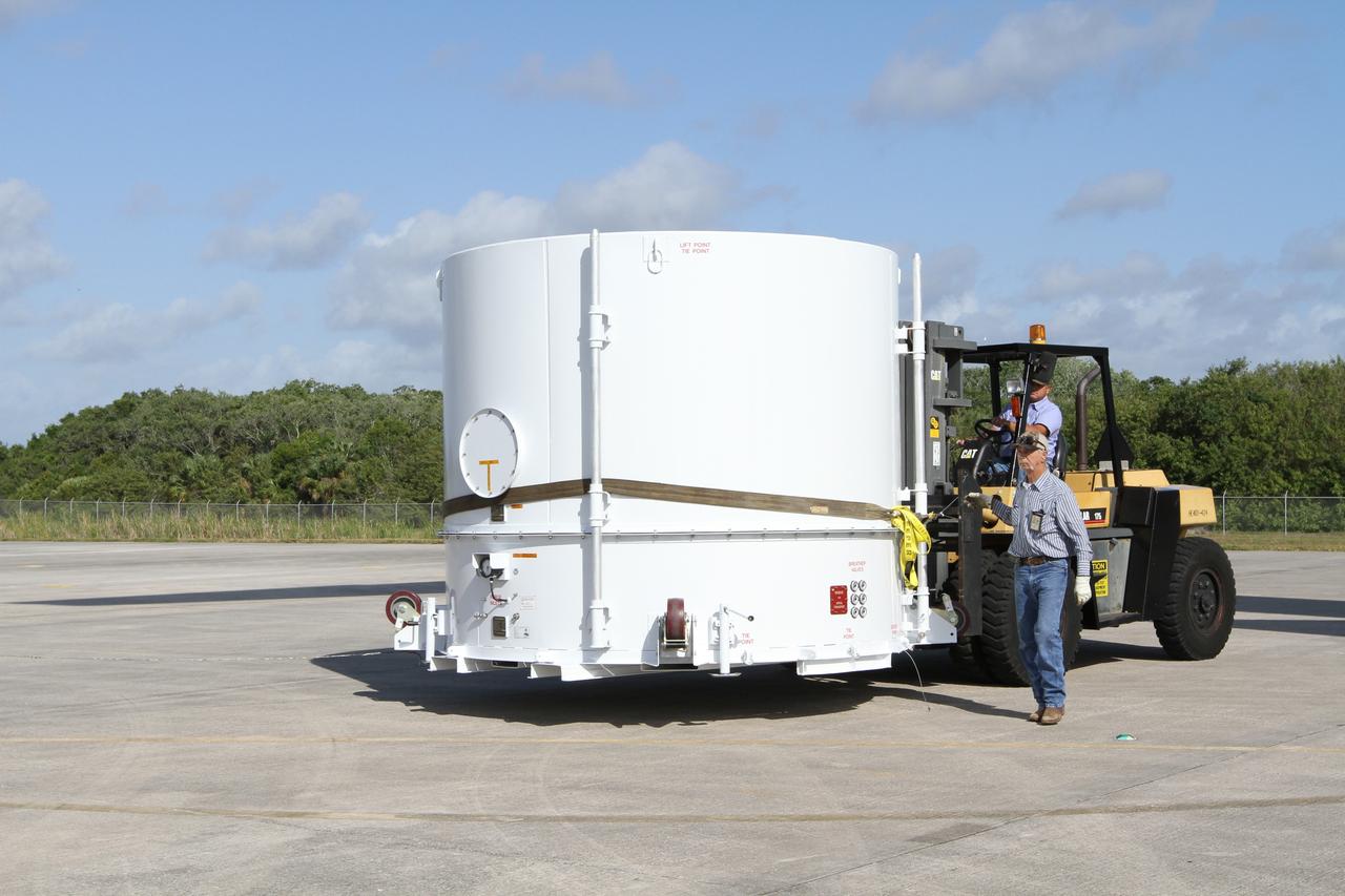 CAPE CANAVERAL, Fla. – A forklift operator NASA's Radiation Belt Storm Probe A, enclosed in a protective shipping container, toward a flatbed truck at the Shuttle Landing Facility at NASA’s Kennedy Space Center in Florida.  The twin RBSP spacecraft will be transported to the Astrotech payload processing facility near Kennedy Space Center where Applied Physics Laboratory technicians will begin spacecraft testing and prelaunch preparations.          The RBSP mission will help us understand the sun’s influence on Earth and near-Earth space by studying the Earth’s radiation belts on various scales of space and time. The RBSP instruments will provide the measurements needed to characterize and quantify the plasma processes that produce very energetic ions and relativistic electrons. The mission is part of NASA’s broader Living With a Star Program that was conceived to explore fundamental processes that operate throughout the solar system, and in particular those that generate hazardous space weather effects in the vicinity of Earth and phenomena that could impact solar system exploration. RBSP is scheduled to begin its mission of exploration of Earth's Van Allen Radiation Belts and the extremes of space weather after launch. Launch aboard a United Launch Alliance Atlas V rocket is scheduled for August 23.  For more information, visit http://www.nasa.gov/rbsp.  Photo credit: NASA/Kim Shiflett