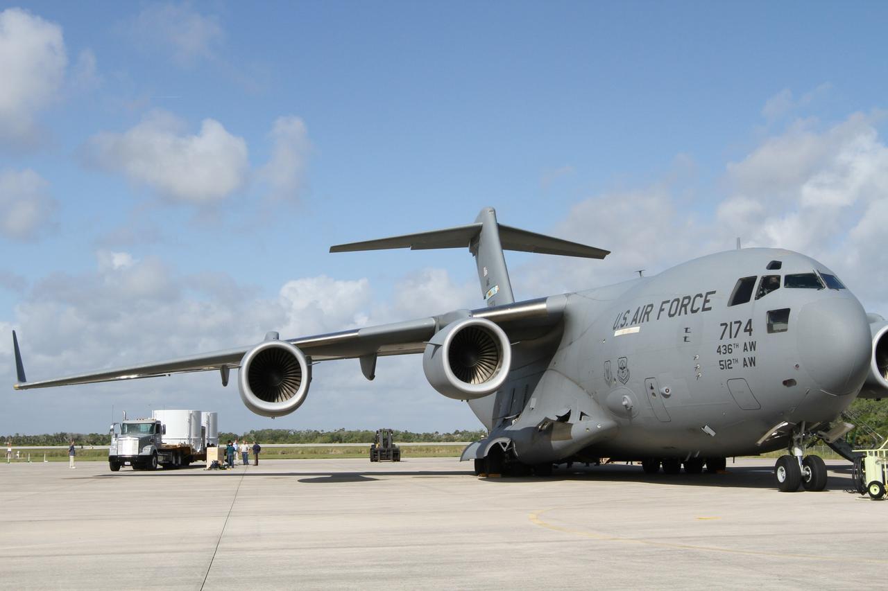 CAPE CANAVERAL, Fla. – NASA's twin Radiation Belt Storm Probes, enclosed in protective shipping containers, have been secured on a flatbed truck at the Shuttle Landing Facility at NASA’s Kennedy Space Center in Florida. The spacecraft will be transported to the Astrotech payload processing facility near Kennedy Space Center where Applied Physics Laboratory technicians will begin spacecraft testing and prelaunch preparations. The spacecraft arrived at Kennedy in the cargo bay of the U.S. Air Force C-17 airplane at right. The RBSP mission will help us understand the sun’s influence on Earth and near-Earth space by studying the Earth’s radiation belts on various scales of space and time. The RBSP instruments will provide the measurements needed to characterize and quantify the plasma processes that produce very energetic ions and relativistic electrons. The mission is part of NASA’s broader Living With a Star Program that was conceived to explore fundamental processes that operate throughout the solar system, and in particular those that generate hazardous space weather effects in the vicinity of Earth and phenomena that could impact solar system exploration. RBSP is scheduled to begin its mission of exploration of Earth's Van Allen Radiation Belts and the extremes of space weather after launch. Launch aboard a United Launch Alliance Atlas V rocket is scheduled for August 23. For more information, visit http://www.nasa.gov/rbsp. Photo credit: NASA/Kim Shiflett