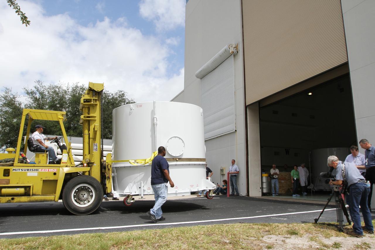 CAPE CANAVERAL, Fla. – A forklift operator moves NASA's Radiation Belt Storm Probe B, enclosed in a protective shipping container, toward the open bay door of the Astrotech payload processing facility near NASA’s Kennedy Space Center in Florida where Applied Physics Laboratory technicians will begin spacecraft testing and prelaunch preparations.  The twin RBSP spacecraft arrived at Kennedy’s Shuttle Landing Facility in the cargo bay of a U.S. Air Force C-17 aircraft earlier in the day.          The RBSP mission will help us understand the sun’s influence on Earth and near-Earth space by studying the Earth’s radiation belts on various scales of space and time. The RBSP instruments will provide the measurements needed to characterize and quantify the plasma processes that produce very energetic ions and relativistic electrons. The mission is part of NASA’s broader Living With a Star Program that was conceived to explore fundamental processes that operate throughout the solar system, and in particular those that generate hazardous space weather effects in the vicinity of Earth and phenomena that could impact solar system exploration. RBSP is scheduled to begin its mission of exploration of Earth's Van Allen Radiation Belts and the extremes of space weather after launch. Launch aboard a United Launch Alliance Atlas V rocket is scheduled for August 23.  For more information, visit http://www.nasa.gov/rbsp.  Photo credit: NASA/Kim Shiflett