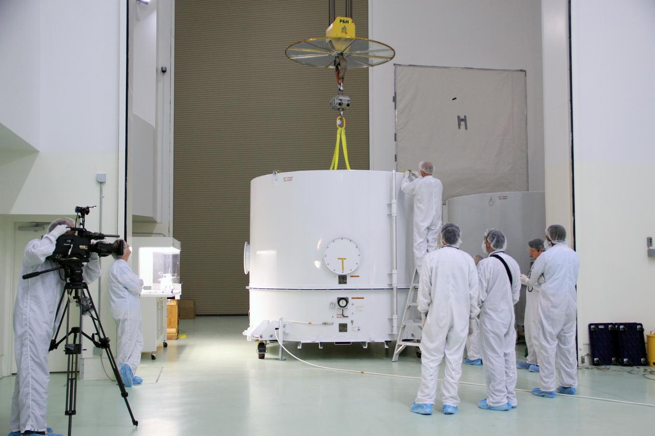 CAPE CANAVERAL, Fla. – In the clean room high bay at the Astrotech payload processing facility near NASA’s Kennedy Space Center in Florida, Applied Physics Laboratory technicians prepare to remove the shipping container from around NASA's Radiation Belt Storm Probe A. Prelaunch preparations and spacecraft testing will follow.    The Radiation Belt Storm Probes, or RBSP, mission will help us understand the sun’s influence on Earth and near-Earth space by studying the Earth’s radiation belts on various scales of space and time. RBSP instruments will provide the measurements needed to characterize and quantify the plasma processes that produce very energetic ions and relativistic electrons. The mission is part of NASA’s broader Living With a Star Program that was conceived to explore fundamental processes that operate throughout the solar system, particularly those that generate hazardous space weather effects in the vicinity of Earth and phenomena that could impact solar system exploration. RBSP will begin its mission of exploration of Earth's Van Allen radiation belts and the extremes of space weather after launch. Launch aboard a United Launch Alliance Atlas V rocket is scheduled for August 23. For more information, visit http://www.nasa.gov/rbsp. Photo credit: NASA/Jim Grossmann