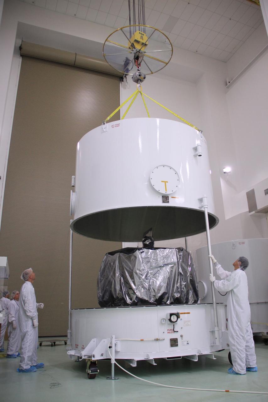 CAPE CANAVERAL, Fla. – In the clean room high bay at the Astrotech payload processing facility near NASA’s Kennedy Space Center in Florida, Applied Physics Laboratory technicians lift the shipping container from around NASA's Radiation Belt Storm Probe A, wrapped in a protective shroud. Prelaunch preparations and spacecraft testing will follow.      The Radiation Belt Storm Probes, or RBSP, mission will help us understand the sun’s influence on Earth and near-Earth space by studying the Earth’s radiation belts on various scales of space and time. RBSP instruments will provide the measurements needed to characterize and quantify the plasma processes that produce very energetic ions and relativistic electrons. The mission is part of NASA’s broader Living With a Star Program that was conceived to explore fundamental processes that operate throughout the solar system, particularly those that generate hazardous space weather effects in the vicinity of Earth and phenomena that could impact solar system exploration. RBSP will begin its mission of exploration of Earth's Van Allen radiation belts and the extremes of space weather after launch. Launch aboard a United Launch Alliance Atlas V rocket is scheduled for August 23. For more information, visit http://www.nasa.gov/rbsp. Photo credit: NASA/Jim Grossmann