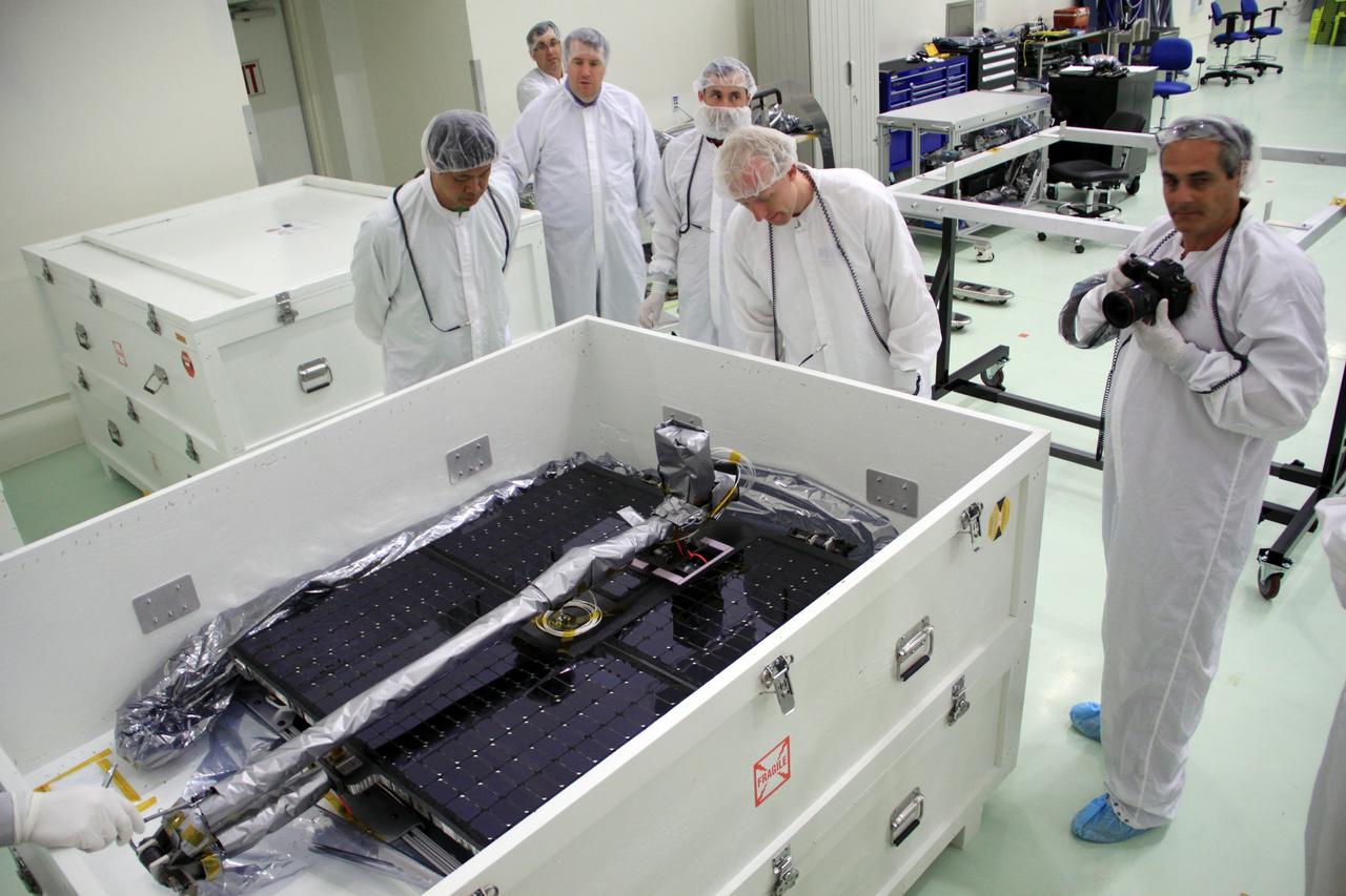 CAPE CANAVERAL, Fla. – In the clean room high bay at the Astrotech payload processing facility near NASA’s Kennedy Space Center in Florida, Applied Physics Laboratory technicians prepare to place one of the solar arrays for NASA's Radiation Belt Storm Probe A into a holding fixture.      The Radiation Belt Storm Probes, or RBSP, mission will help us understand the sun’s influence on Earth and near-Earth space by studying the Earth’s radiation belts on various scales of space and time. RBSP instruments will provide the measurements needed to characterize and quantify the plasma processes that produce very energetic ions and relativistic electrons. The mission is part of NASA’s broader Living With a Star Program that was conceived to explore fundamental processes that operate throughout the solar system, particularly those that generate hazardous space weather effects in the vicinity of Earth and phenomena that could impact solar system exploration. RBSP will begin its mission of exploration of Earth's Van Allen radiation belts and the extremes of space weather after launch. Launch aboard a United Launch Alliance Atlas V rocket is scheduled for August 23. For more information, visit http://www.nasa.gov/rbsp. Photo credit: NASA/Jim Grossmann
