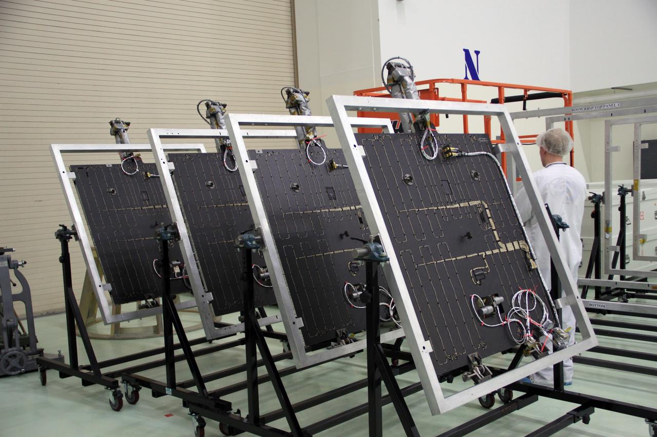 CAPE CANAVERAL, Fla. – Holding fixtures containing the solar arrays for NASA's Radiation Belt Storm Probe A line the floor of the clean room high bay at the Astrotech payload processing facility near NASA’s Kennedy Space Center in Florida. The Radiation Belt Storm Probes, or RBSP, mission will help us understand the sun’s influence on Earth and near-Earth space by studying the Earth’s radiation belts on various scales of space and time. RBSP instruments will provide the measurements needed to characterize and quantify the plasma processes that produce very energetic ions and relativistic electrons. The mission is part of NASA’s broader Living With a Star Program that was conceived to explore fundamental processes that operate throughout the solar system, particularly those that generate hazardous space weather effects in the vicinity of Earth and phenomena that could impact solar system exploration. RBSP will begin its mission of exploration of Earth's Van Allen radiation belts and the extremes of space weather after launch. Launch aboard a United Launch Alliance Atlas V rocket is scheduled for August 23. For more information, visit http://www.nasa.gov/rbsp. Photo credit: NASA/Jim Grossmann