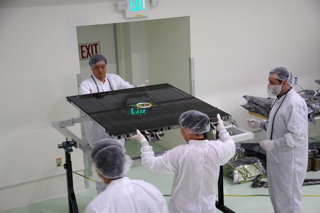 CAPE CANAVERAL, Fla. – In the clean room high bay at the Astrotech payload processing facility near NASA’s Kennedy Space Center in Florida, Applied Physics Laboratory technicians unpack one of the solar arrays for NASA's Radiation Belt Storm Probe B.      The Radiation Belt Storm Probes, or RBSP, mission will help us understand the sun’s influence on Earth and near-Earth space by studying the Earth’s radiation belts on various scales of space and time. RBSP instruments will provide the measurements needed to characterize and quantify the plasma processes that produce very energetic ions and relativistic electrons. The mission is part of NASA’s broader Living With a Star Program that was conceived to explore fundamental processes that operate throughout the solar system, particularly those that generate hazardous space weather effects in the vicinity of Earth and phenomena that could impact solar system exploration. RBSP will begin its mission of exploration of Earth's Van Allen radiation belts and the extremes of space weather after launch. Launch aboard a United Launch Alliance Atlas V rocket is scheduled for August 23. For more information, visit http://www.nasa.gov/rbsp. Photo credit: NASA/Jim Grossmann
