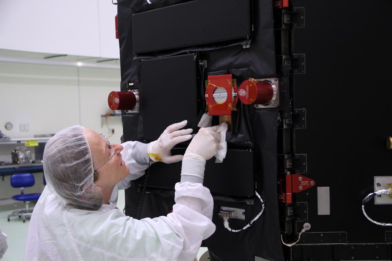 CAPE CANAVERAL, Fla. – In the clean room high bay at the Astrotech payload processing facility near NASA’s Kennedy Space Center in Florida, an Applied Physics Laboratory technician cleans NASA's Radiation Belt Storm Probe B.  Prelaunch preparations and spacecraft testing will follow.      The Radiation Belt Storm Probes, or RBSP, mission will help us understand the sun’s influence on Earth and near-Earth space by studying the Earth’s radiation belts on various scales of space and time. RBSP instruments will provide the measurements needed to characterize and quantify the plasma processes that produce very energetic ions and relativistic electrons. The mission is part of NASA’s broader Living With a Star Program that was conceived to explore fundamental processes that operate throughout the solar system, particularly those that generate hazardous space weather effects in the vicinity of Earth and phenomena that could impact solar system exploration. RBSP will begin its mission of exploration of Earth's Van Allen radiation belts and the extremes of space weather after launch. Launch aboard a United Launch Alliance Atlas V rocket is scheduled for August 23. For more information, visit http://www.nasa.gov/rbsp. Photo credit: NASA/Jim Grossmann