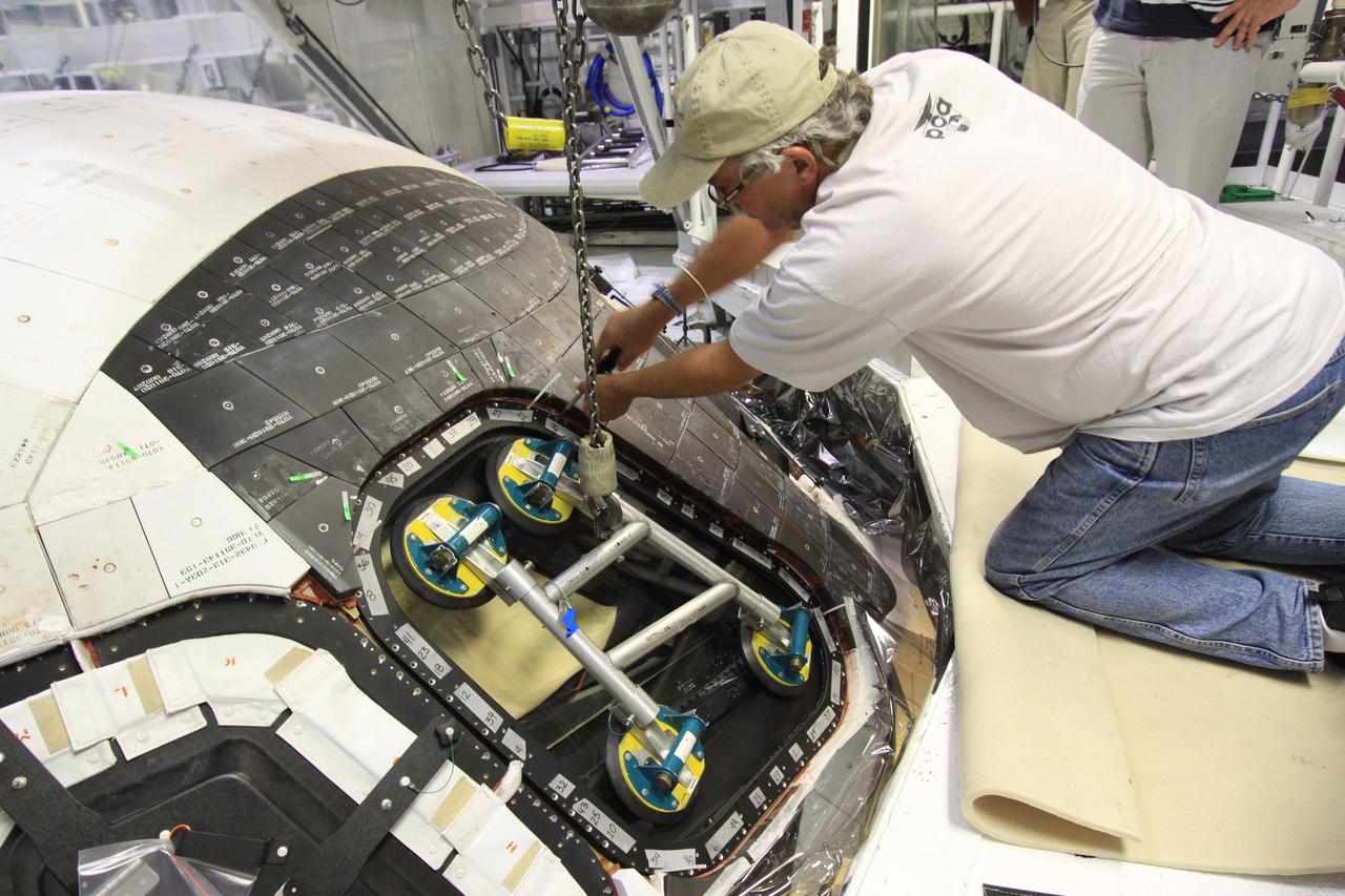 CAPE CANAVERAL, Fla. – Inside Orbiter Processing Facility-1 at NASA’s Kennedy Space Center in Florida, a United Space Alliance technician installs a component of window No. 4 on space shuttle Atlantis.     The work is part of the Space Shuttle Program’s transition and retirement processing of space shuttles Atlantis and Endeavour. Atlantis is being prepared for display at the Kennedy Space Center Visitor Complex and is scheduled to roll over to the complex in November. The visitor complex is targeting a July 2013 grand opening for Atlantis’ new home. Photo credit: NASA/Jim Grossmann