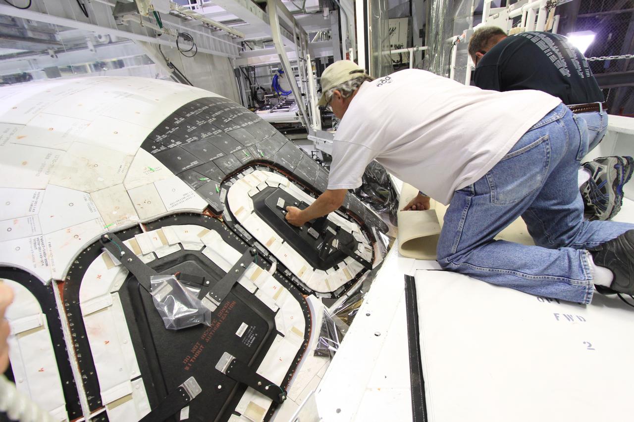 CAPE CANAVERAL, Fla. – Inside Orbiter Processing Facility-1 at NASA’s Kennedy Space Center in Florida, a United Space Alliance technician installs a component of window No. 4 on space shuttle Atlantis.    The work is part of the Space Shuttle Program’s transition and retirement processing of space shuttles Atlantis and Endeavour. Atlantis is being prepared for display at the Kennedy Space Center Visitor Complex and is scheduled to roll over to the complex in November. The visitor complex is targeting a July 2013 grand opening for Atlantis’ new home. Photo credit: NASA/Jim Grossmann