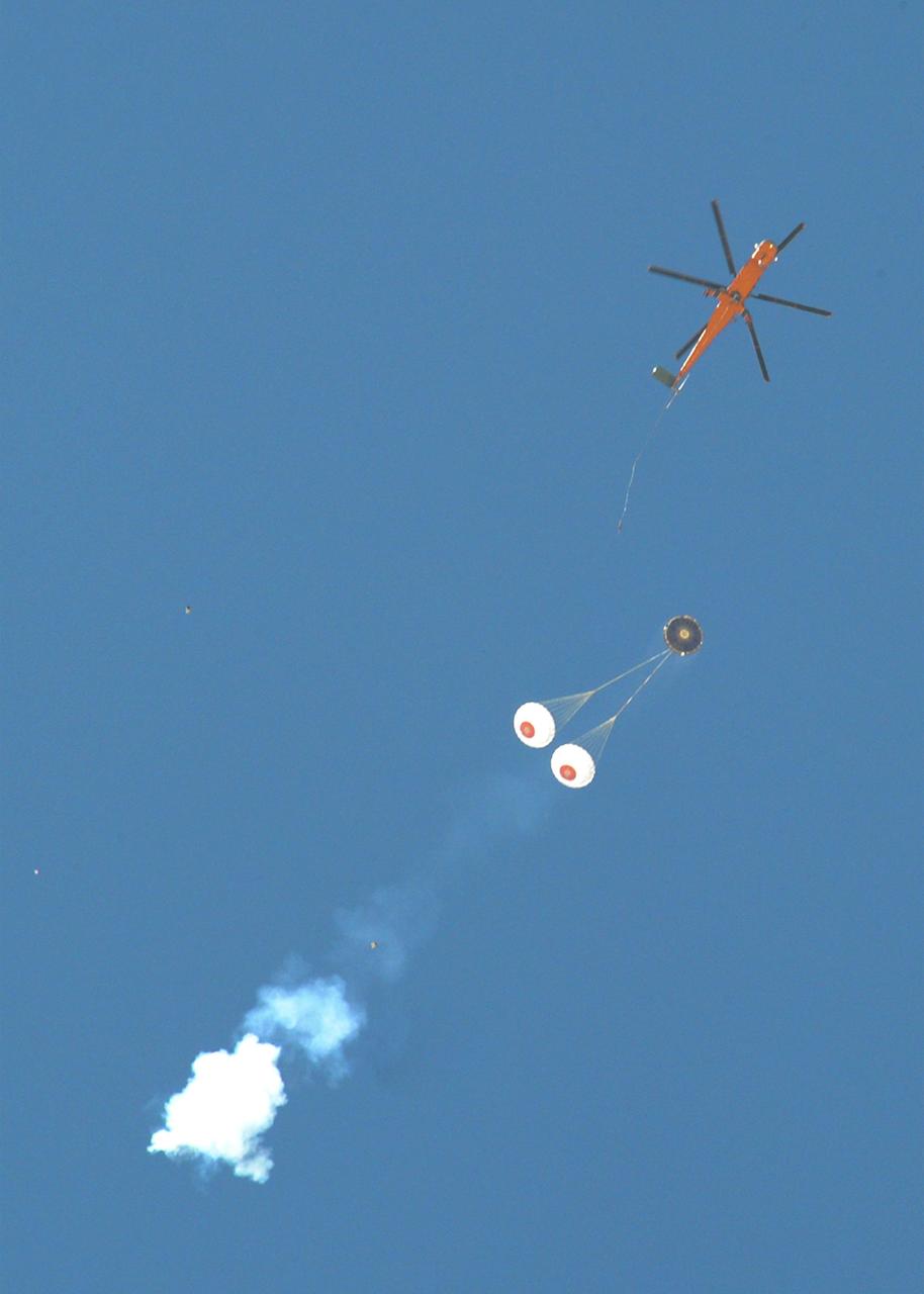DELAMAR DRY LAKE BED, Nev. – An Erickson Sky Crane helicopter releases The Boeing Company's CST-100 crew capsule over the Delamar Dry Lake Bed near Alamo, Nev., where it floated to a smooth landing beneath its parachute system. This is the second parachute test that Boeing performed under its partnership with NASA's Commercial Crew Program CCP. The first showed the parachute system’s deployment scheme worked and that it could be re-packed and re-used for this second test.           In 2011, NASA selected Boeing during Commercial Crew Development Round 2 CCDev2) activities to mature the design and development of a crew transportation system with the overall goal of accelerating a United States-led capability to the International Space Station. The goal of CCP is to drive down the cost of space travel as well as open up space to more people than ever before by balancing industry’s own innovative capabilities with NASA's 50 years of human spaceflight experience. Six other aerospace companies also are maturing launch vehicle and spacecraft designs under CCDev2, including Alliant Techsystems Inc. ATK, Excalibur Almaz Inc., Blue Origin, Sierra Nevada, Space Exploration Technologies SpaceX, and United Launch Alliance ULA. For more information, visit www.nasa.gov/commercialcrew. Image credit: Boeing