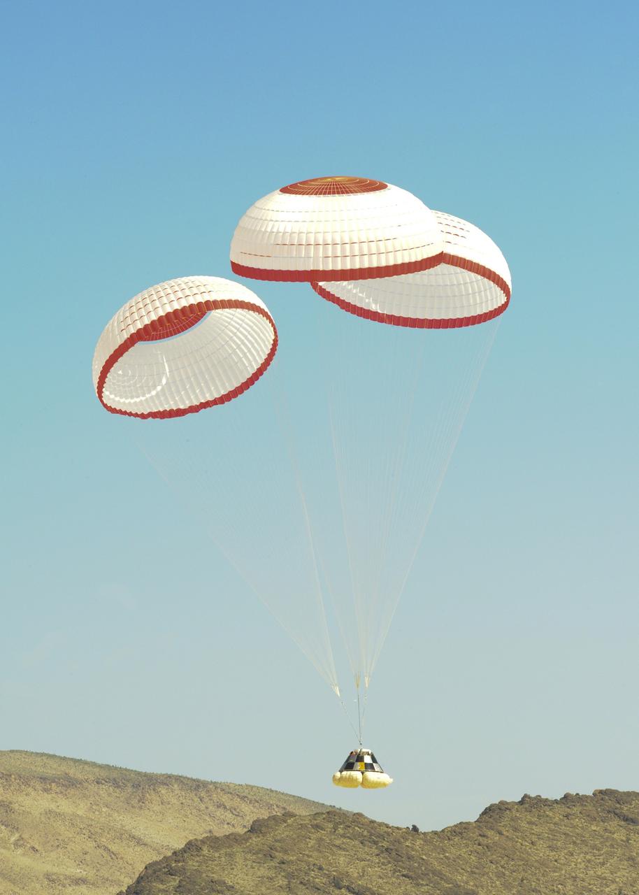 DELAMAR DRY LAKE BED, Nev. – The Boeing Company's CST-100 crew capsule floats to a smooth landing beneath three main parachutes over the Delamar Dry Lake Bed near Alamo, Nev. This is the second parachute test that Boeing performed under its partnership with NASA's Commercial Crew Program CCP. The first showed the parachute system’s deployment scheme worked and that it could be re-packed and re-used for this second test.      In 2011, NASA selected Boeing during Commercial Crew Development Round 2 CCDev2) activities to mature the design and development of a crew transportation system with the overall goal of accelerating a United States-led capability to the International Space Station. The goal of CCP is to drive down the cost of space travel as well as open up space to more people than ever before by balancing industry’s own innovative capabilities with NASA's 50 years of human spaceflight experience. Six other aerospace companies also are maturing launch vehicle and spacecraft designs under CCDev2, including Alliant Techsystems Inc. ATK, Excalibur Almaz Inc., Blue Origin, Sierra Nevada, Space Exploration Technologies SpaceX, and United Launch Alliance ULA. For more information, visit www.nasa.gov/commercialcrew. Image credit: Boeing