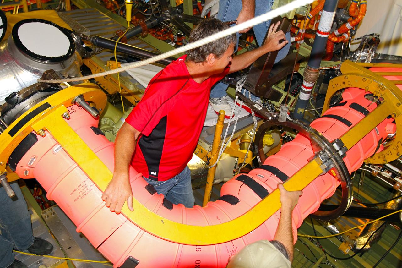CAPE CANAVERAL, Fla. – In Orbiter Processing Facility-1 at NASA’s Kennedy Space Center in Florida, United Space Alliance technicians remove the fuel line that supplied liquid hydrogen propellant to space shuttle Atlantis’ main engine No. 2. The liquid hydrogen lines will be placed in storage to preserve the option to reuse them on NASA’s Space Launch System heavy-lift vehicle, under development. The work is part of the Space Shuttle Program’s transition and retirement processing of shuttle Atlantis. A groundbreaking was held Jan. 18 for Atlantis' future home, a 65,000-square-foot exhibit hall in Shuttle Plaza at the Kennedy Space Center Visitor Complex. Atlantis is scheduled to roll over to the visitor complex in November in preparation for the exhibit’s grand opening in July 2013. For more information, visit http://www.nasa.gov/shuttle. Photo credit: NASA/Ben Smegelsky