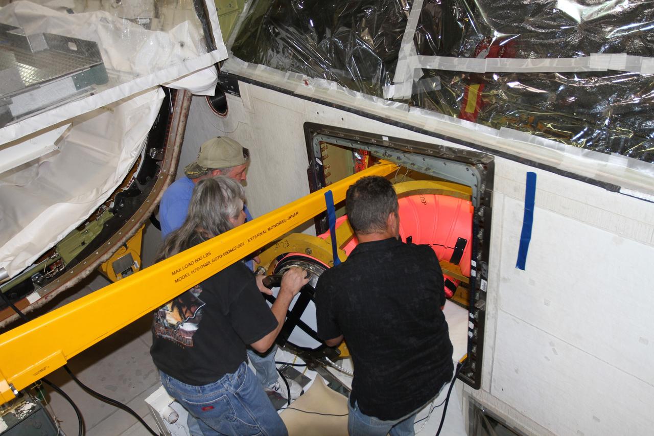 CAPE CANAVERAL, Fla. – In Orbiter Processing Facility-1 at NASA’s Kennedy Space Center in Florida, United Space Alliance technicians work with other technicians inside space shuttle Atlantis’ aft compartment, out of view, to remove the fuel line that supplied liquid hydrogen propellant to Atlantis’ main engine No. 2. The liquid hydrogen lines will be placed in storage to preserve the option to reuse them on NASA’s Space Launch System heavy-lift vehicle, under development. The work is part of the Space Shuttle Program’s transition and retirement processing of shuttle Atlantis. A groundbreaking was held Jan. 18 for Atlantis' future home, a 65,000-square-foot exhibit hall in Shuttle Plaza at the Kennedy Space Center Visitor Complex. Atlantis is scheduled to roll over to the visitor complex in November in preparation for the exhibit’s grand opening in July 2013. For more information, visit http://www.nasa.gov/shuttle. Photo credit: NASA/Ben Smegelsky