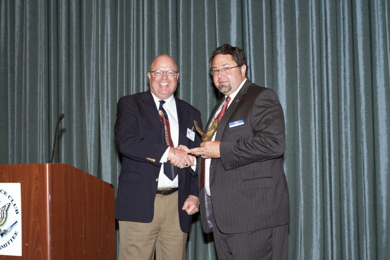 COCOA BEACH, Fla.. -- Todd May, program manager of the Space Launch System, receives a sculpture from the National Space Club after his address to the National Space Club's Florida Committee during the organization's monthly luncheon in Cocoa Beach, Fla. May, who works at NASA's Marshall Space Flight Center in Huntsville, Ala., discussed the status of the SLS program. Photo credit: NASA/Kim Shiflett