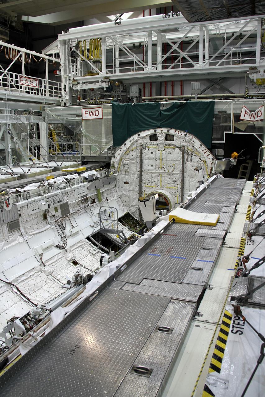 CAPE CANAVERAL, Fla. – In Orbiter Processing Facility-2 at NASA's Kennedy Space Center in Florida, stowage of a Ku-band antenna at the forward end of space shuttle Endeavour’s payload bay is in progress in preparation for final closure of the shuttle’s payload bay doors. The antenna, which resembles a mini-satellite dish, was used to transmit audio, video and data between the shuttle and ground stations on Earth. Endeavour is being prepared for public display at the California Science Center in Los Angeles. Its ferry flight to California is targeted for mid-September. Endeavour was the last space shuttle added to NASA’s orbiter fleet. Over the course of its 19-year career, Endeavour spent 299 days in space during 25 missions. For more information, visit http://www.nasa.gov/transition. Photo credit: NASA/Cory Huston