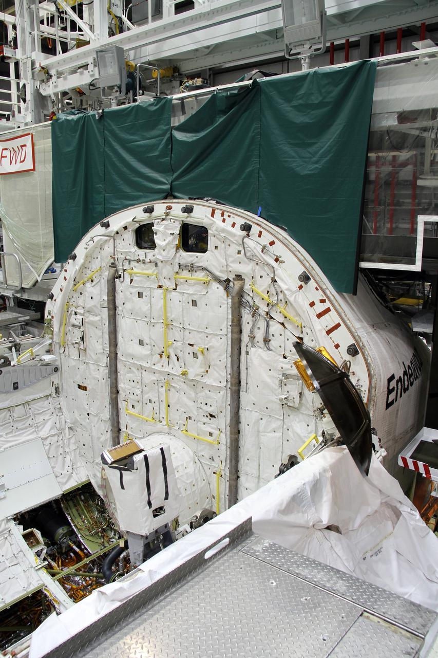 CAPE CANAVERAL, Fla. – In Orbiter Processing Facility-2 at NASA's Kennedy Space Center in Florida, stowage of a Ku-band antenna in space shuttle Endeavour’s payload bay is under way in preparation for final closure of the shuttle’s payload bay doors. The antenna, which resembles a mini-satellite dish, was used to transmit audio, video and data between the shuttle and ground stations on Earth. Endeavour is being prepared for public display at the California Science Center in Los Angeles. Its ferry flight to California is targeted for mid-September. Endeavour was the last space shuttle added to NASA’s orbiter fleet. Over the course of its 19-year career, Endeavour spent 299 days in space during 25 missions. For more information, visit http://www.nasa.gov/transition. Photo credit: NASA/Cory Huston